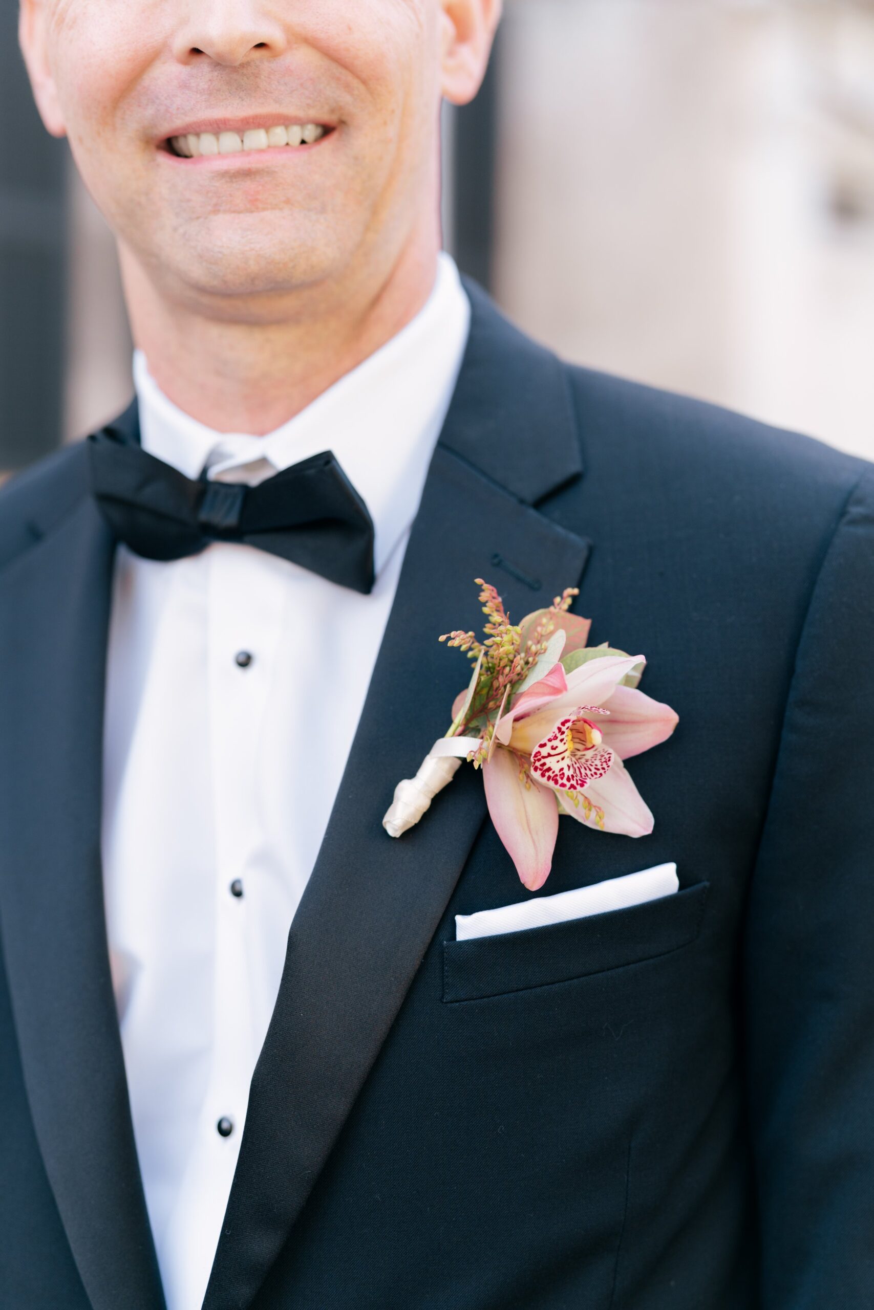black tie groom with unique boutonniere