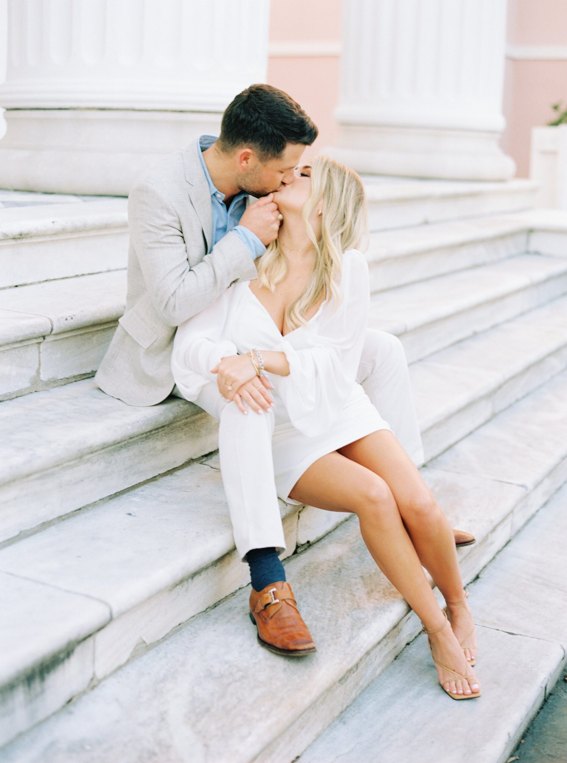 couple sitting and kissing on marble steps