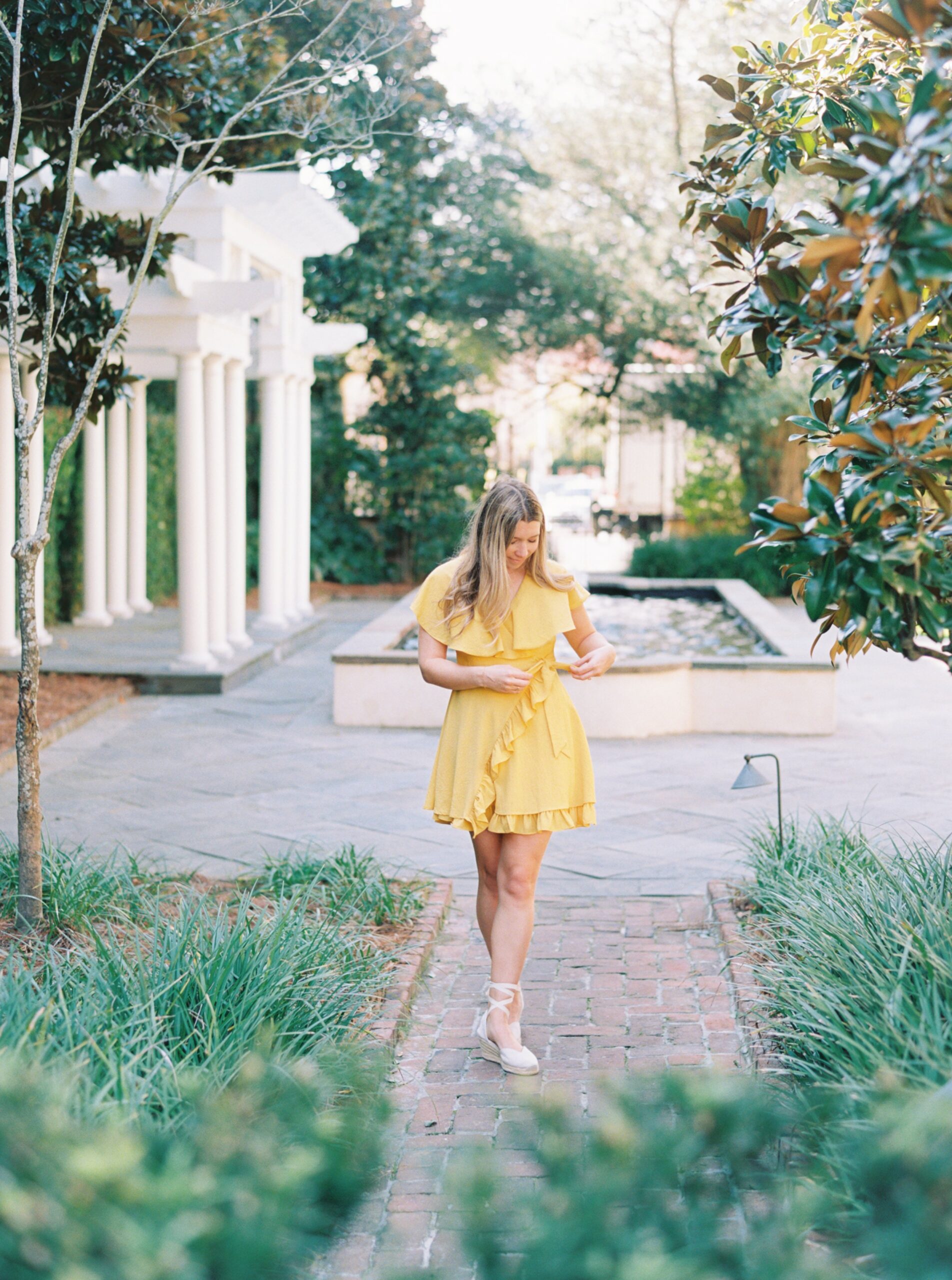 girl in yellow dress in secret garden