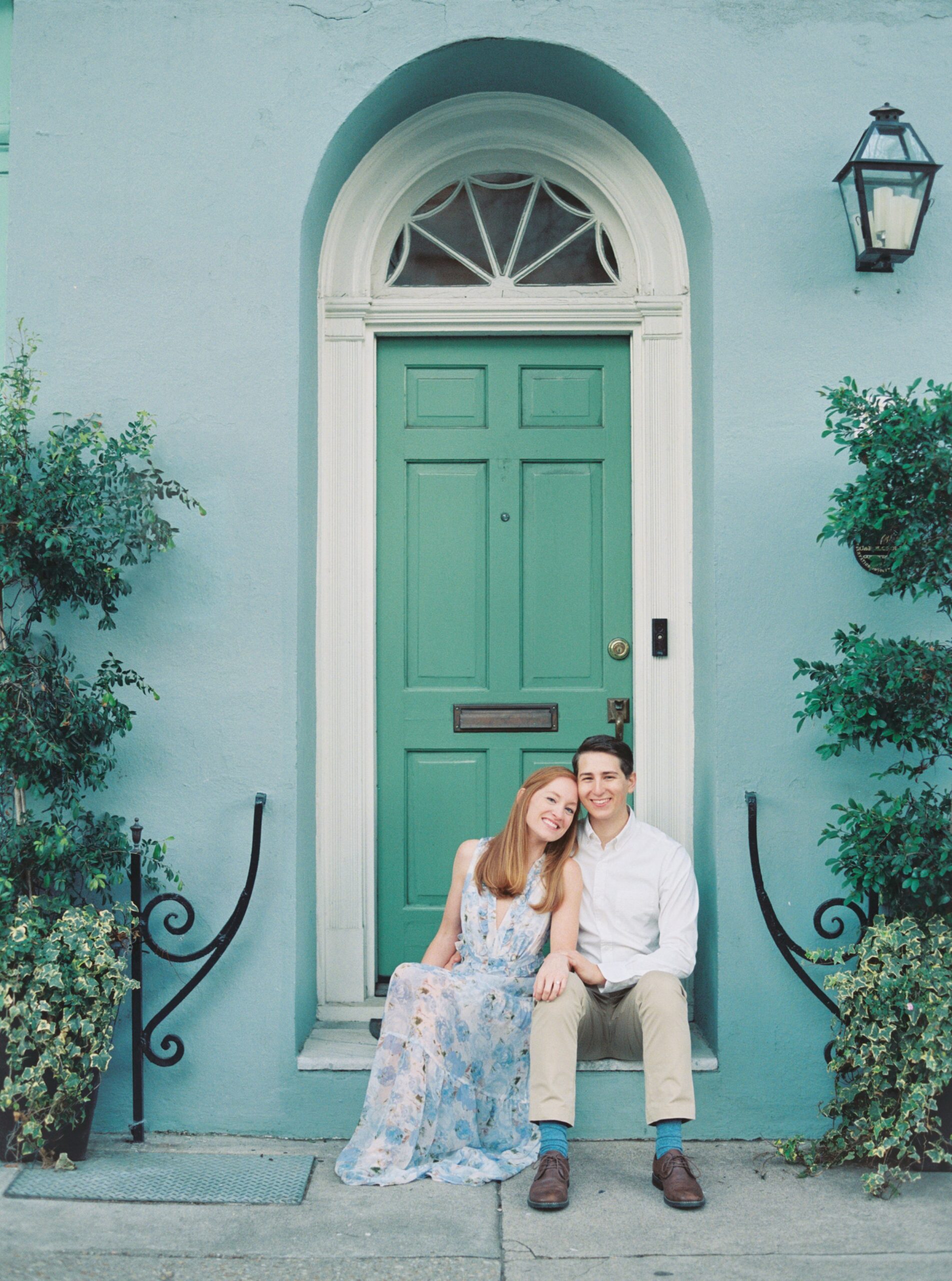 sitting on rainbow row. blue house with green door. Classic charleston