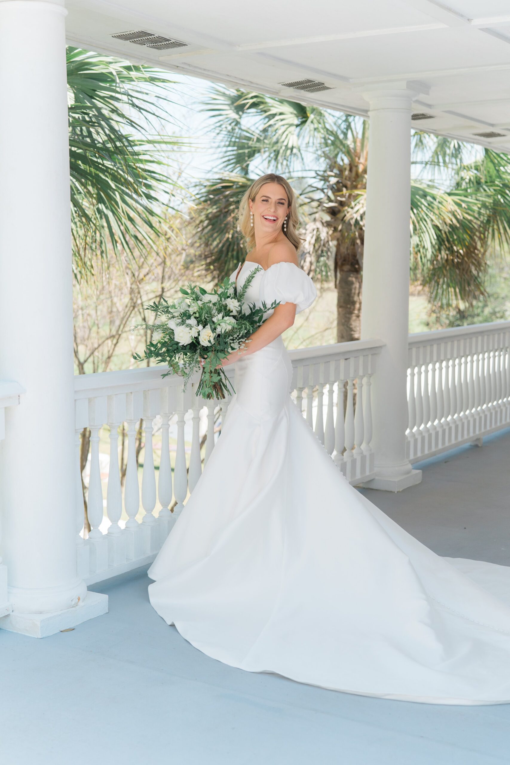 Charleston Spring bride with oversized flowers. White flowers and greenery. Palm trees and porches. Old wide awake.