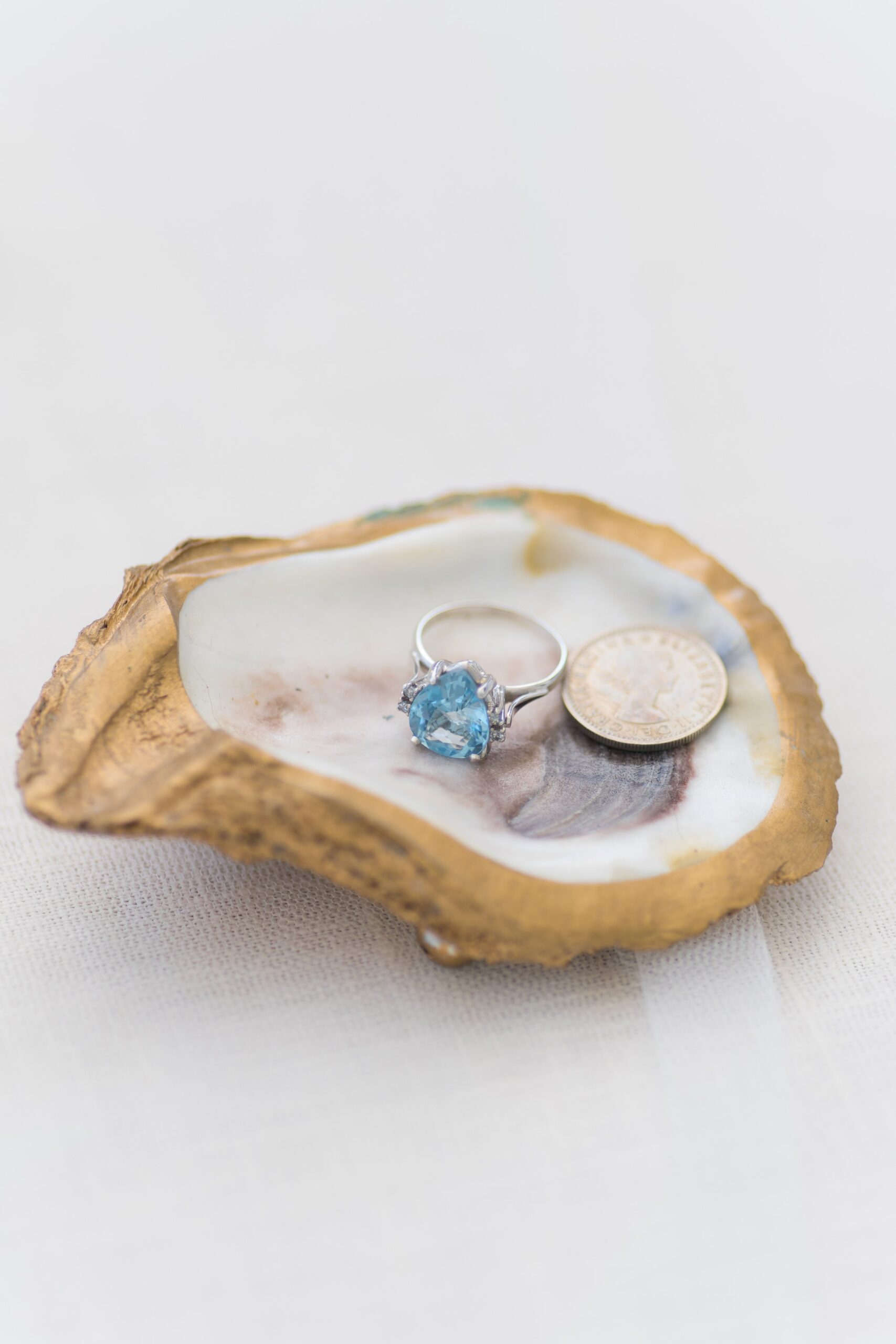 Gold painted oyster shell with heirloom ring.