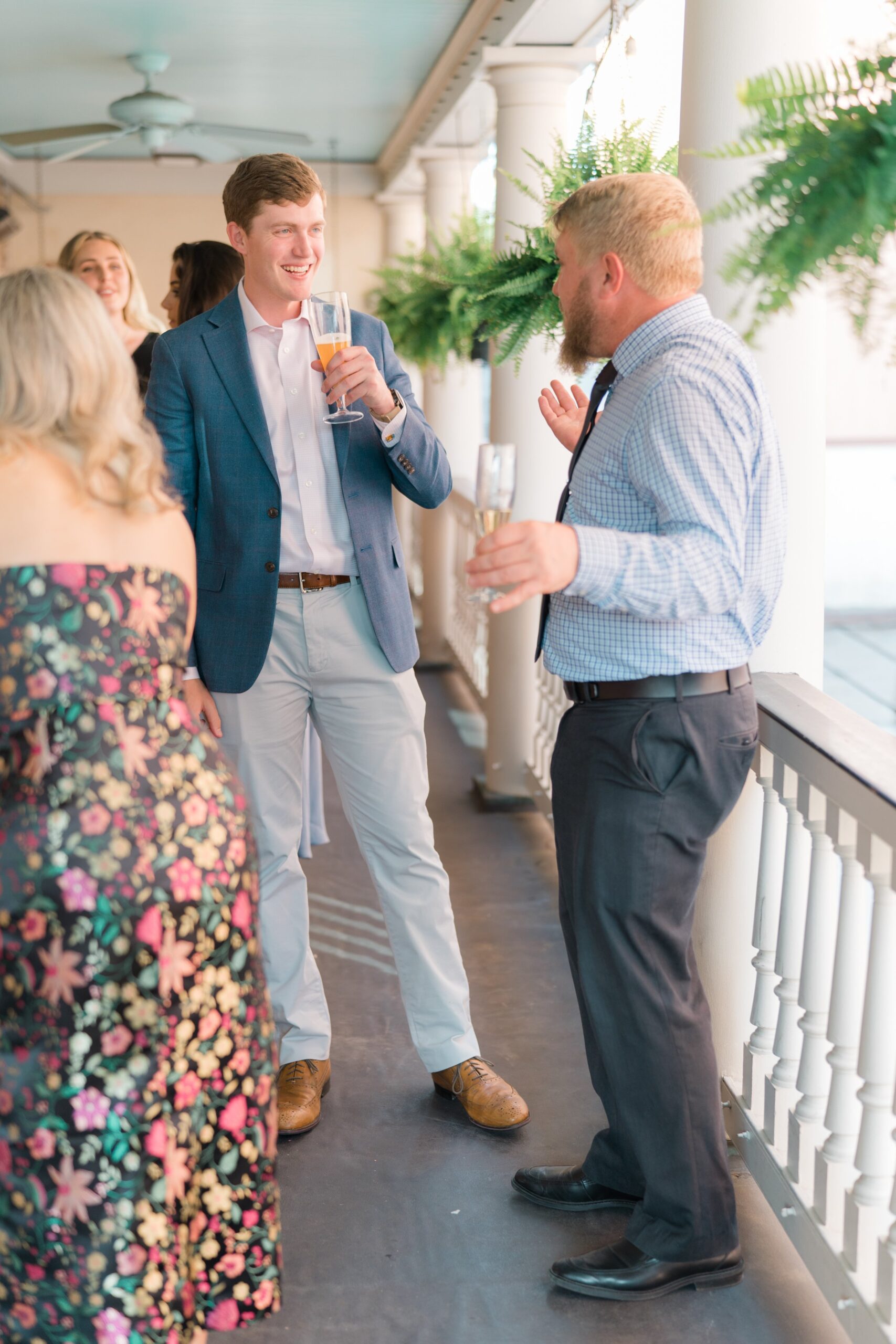 groom talks to guests while sipping beer at parcel 32.