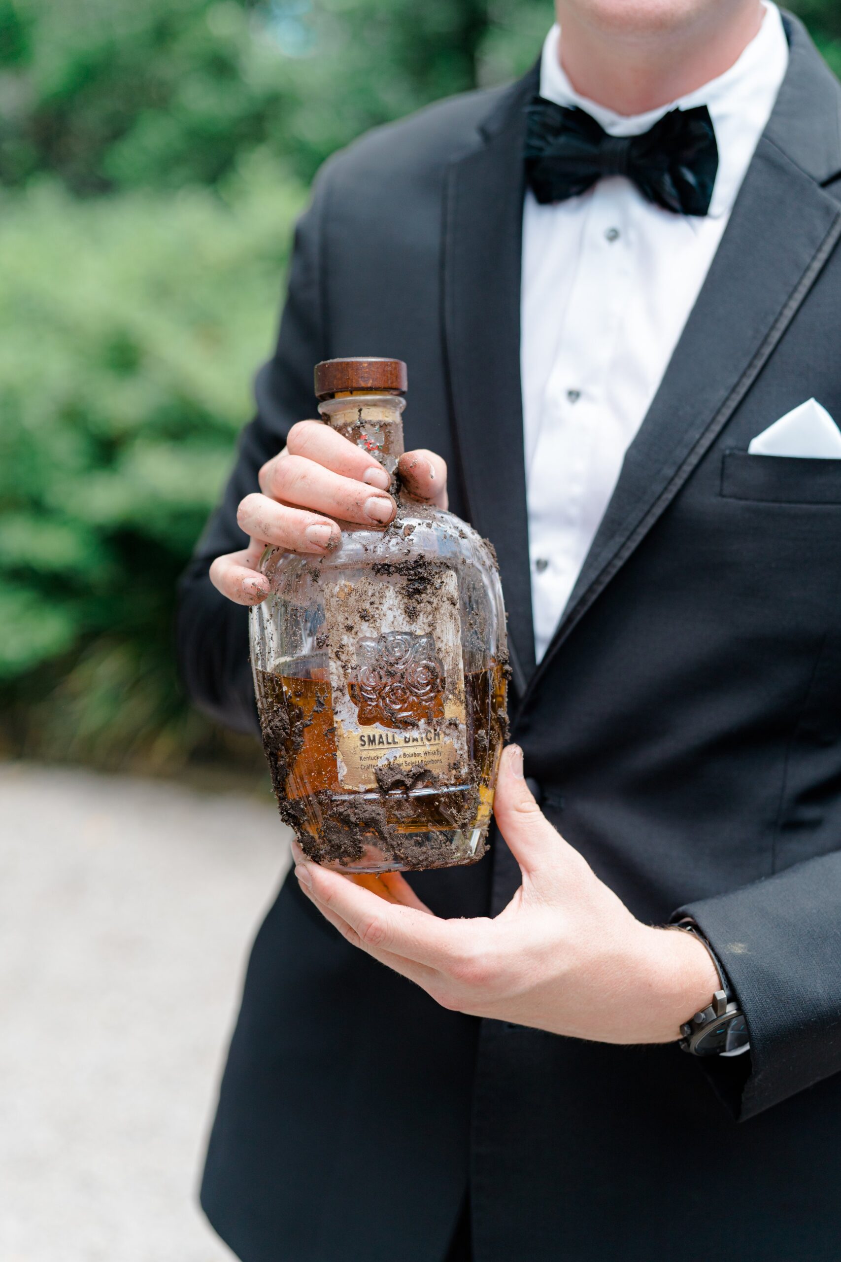 dirty bourbon bottle. Bury the bourbon southern tradition. Black brackish bowtie.