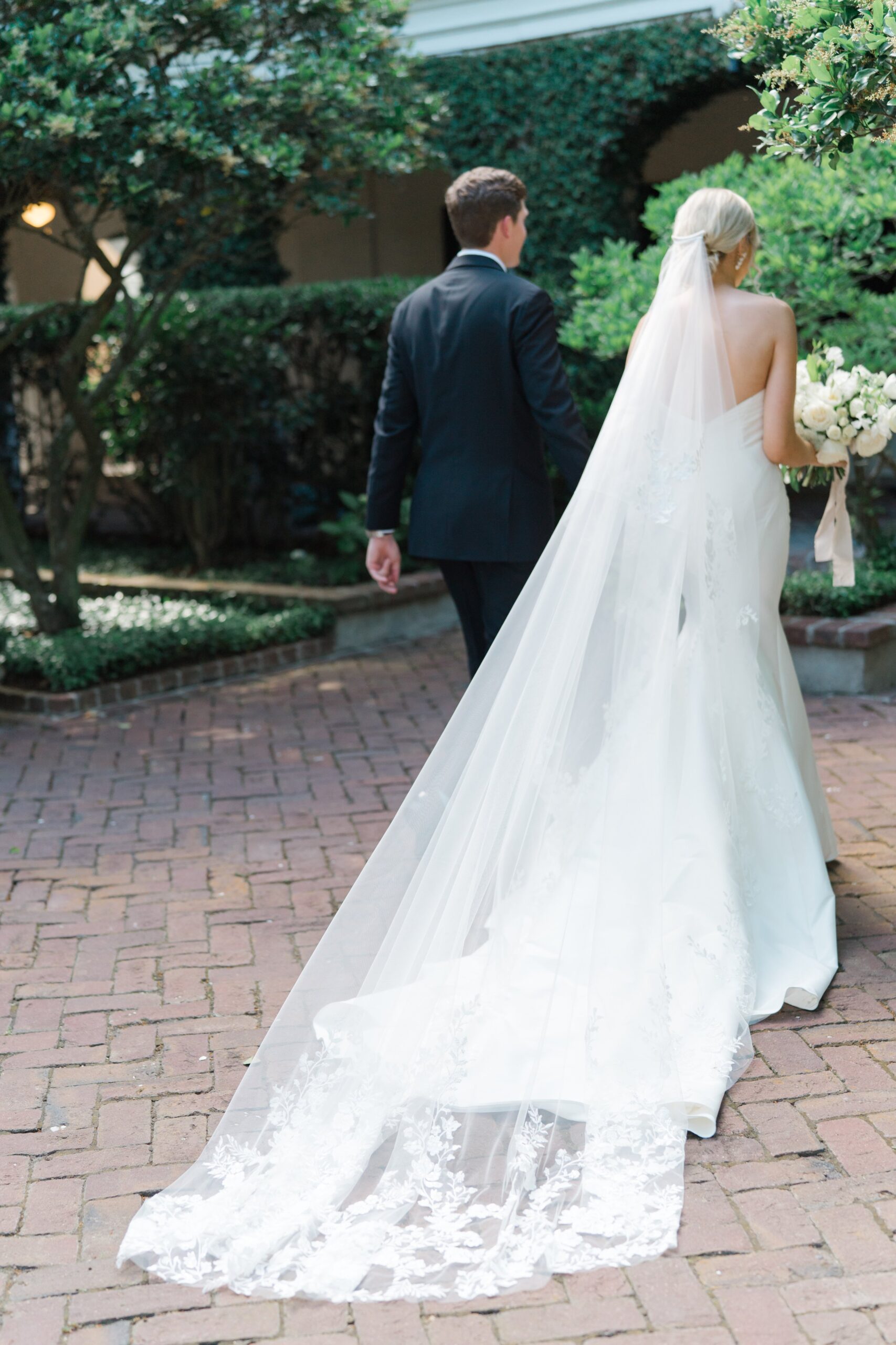 Bride and groom walk away after spring wedding ceremony