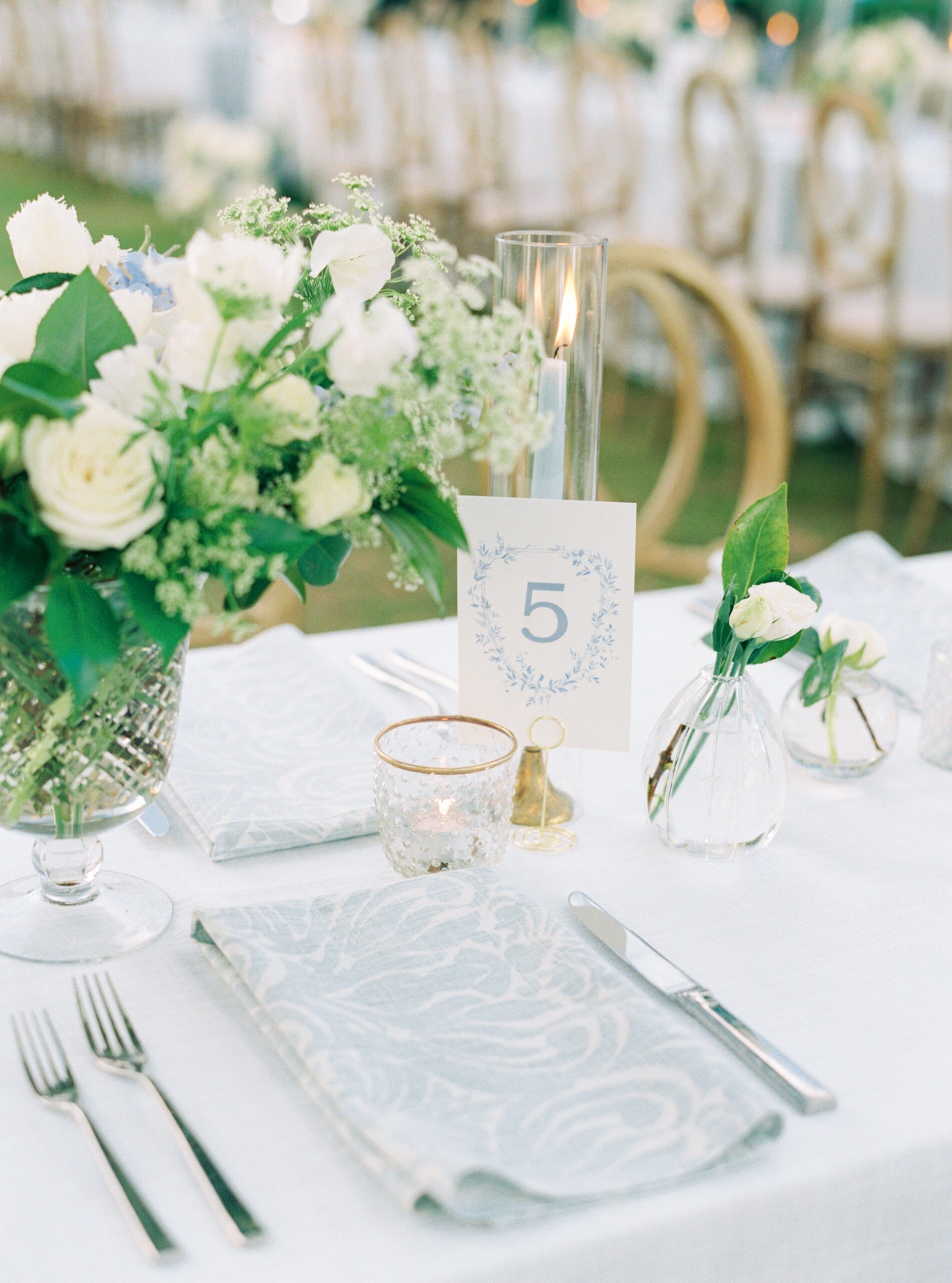 Light blue and white patterned napkins. Charleston spring wedding place setting. Custom table numbers.