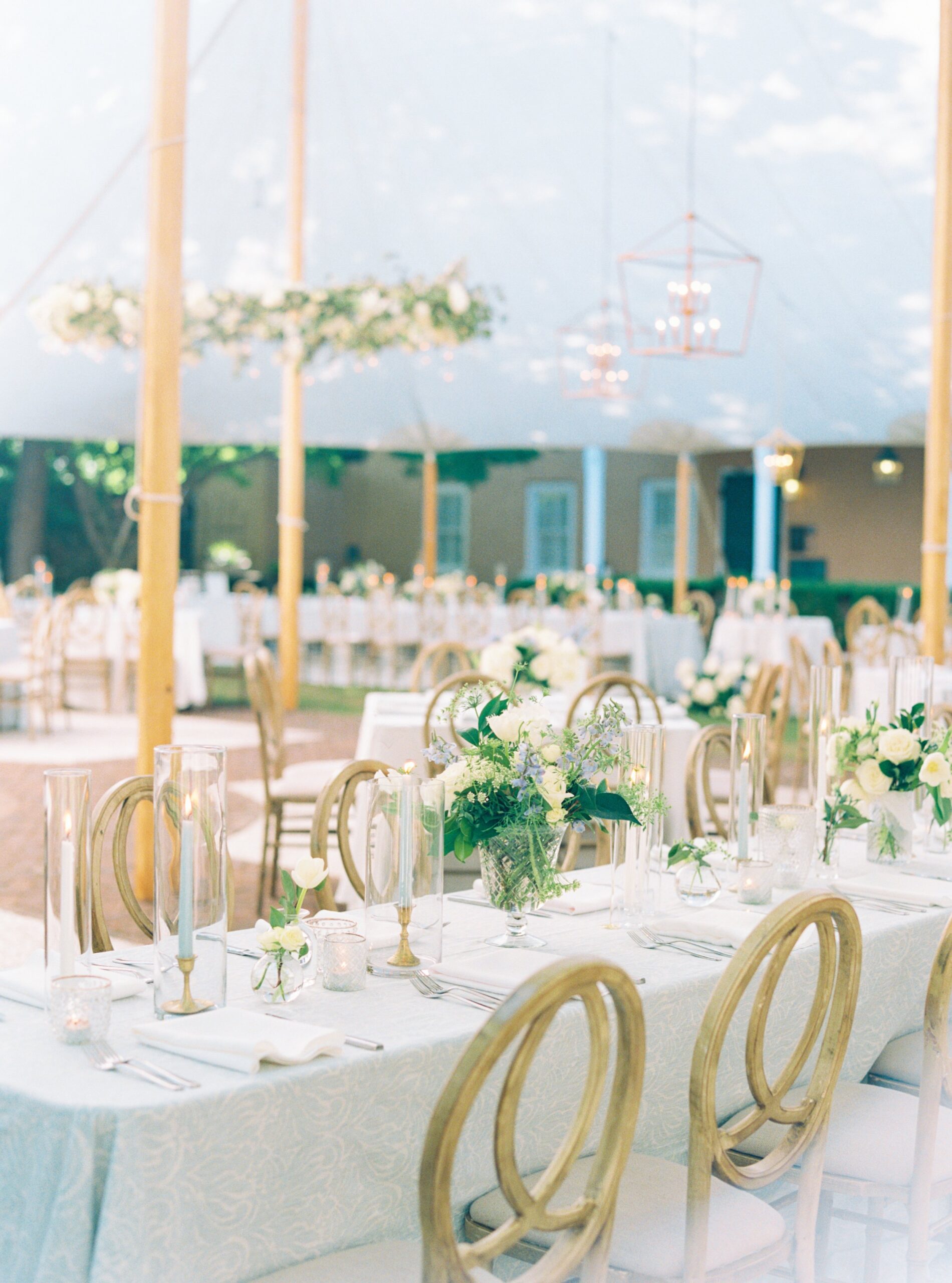 Charleston spring wedding sperry tent with chandeliers and circular hanging floral installation.
