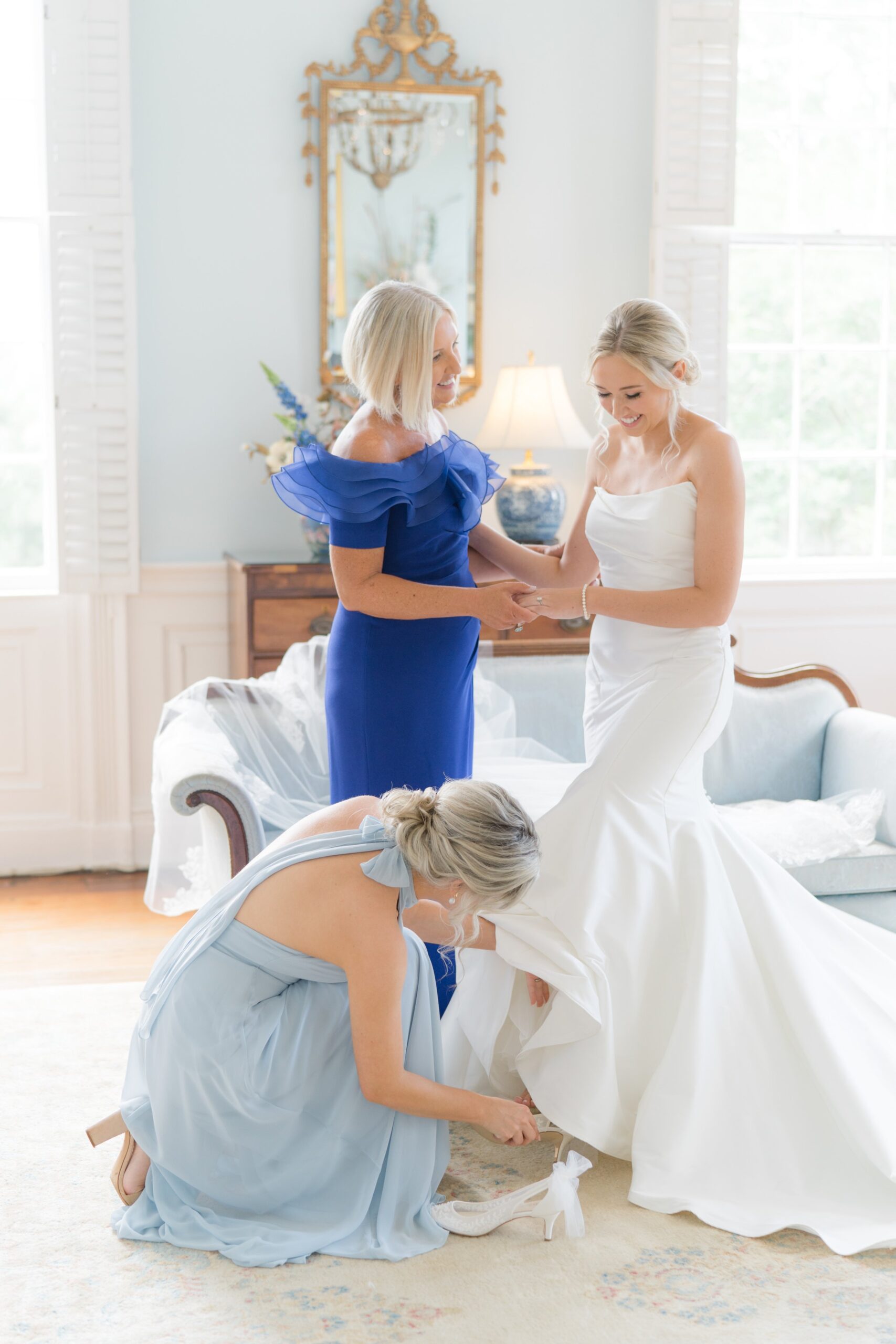 Mom and Maid of Honor help bride put on wedding day heels at Governor Thomas Bennett House