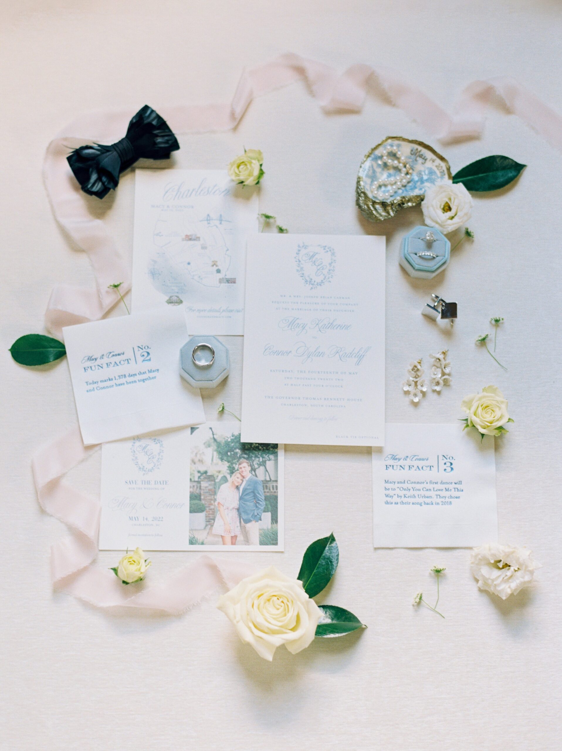 film photography wedding day details. blue and white wedding invitations. light blue ring box. pale pink ribbon. painted oyster shell with pearls.
