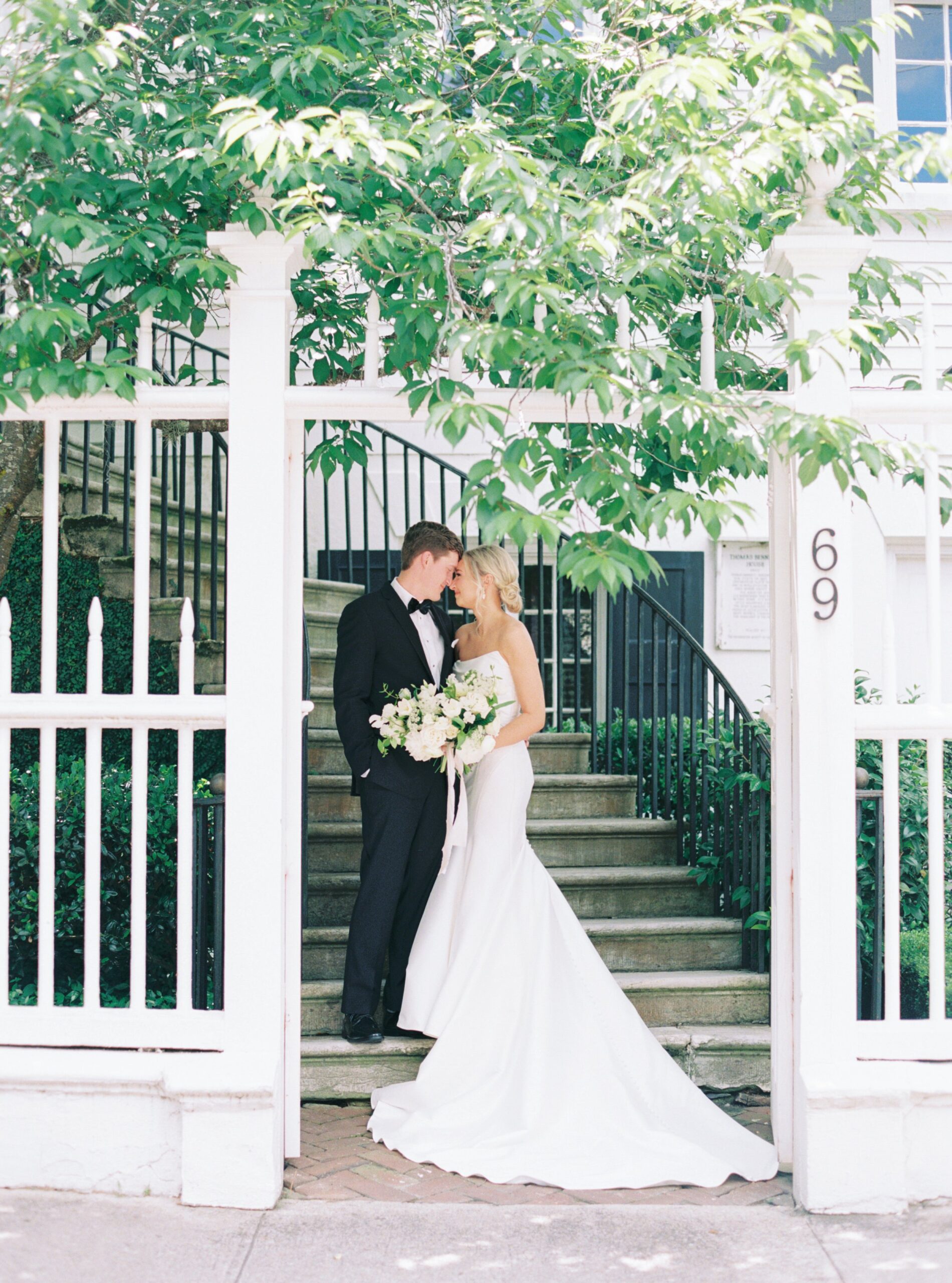 Governor Thomas Bennett House front steps with greenery. Spring bride and groom. Charleston weddings.