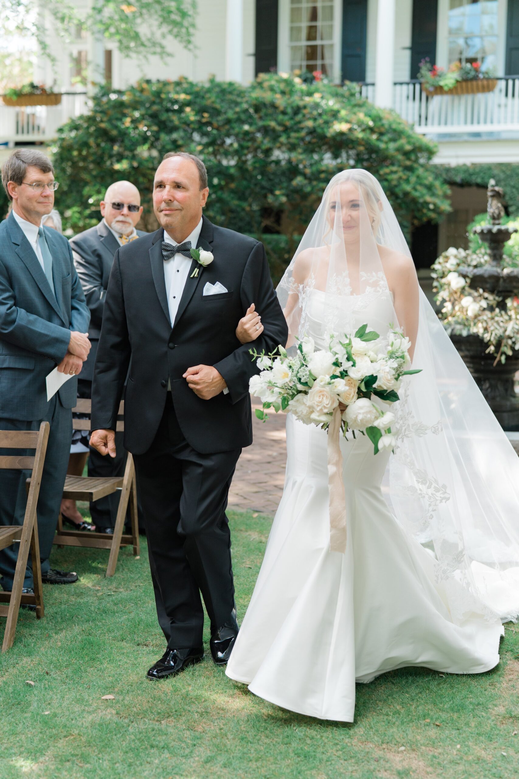 Happy bride walks up the aisle. Charleston wedding photographer.