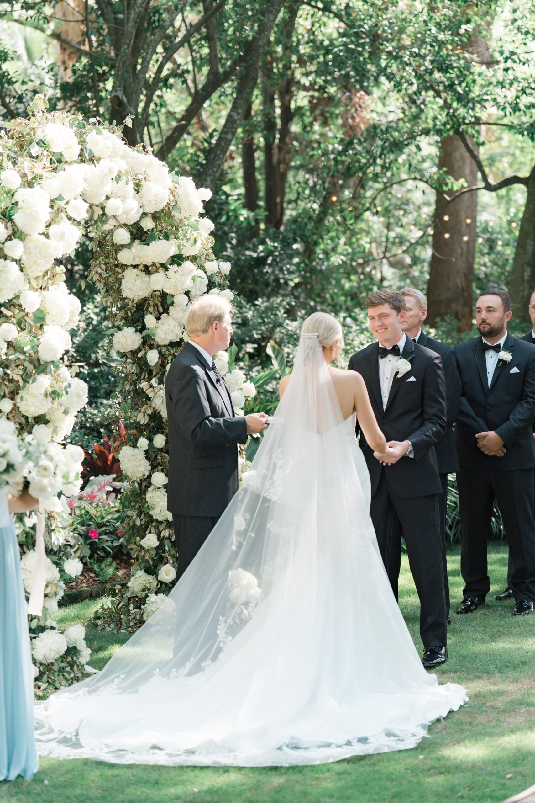 Groom looks at bride during Charleston outdoor wedding ceremony.