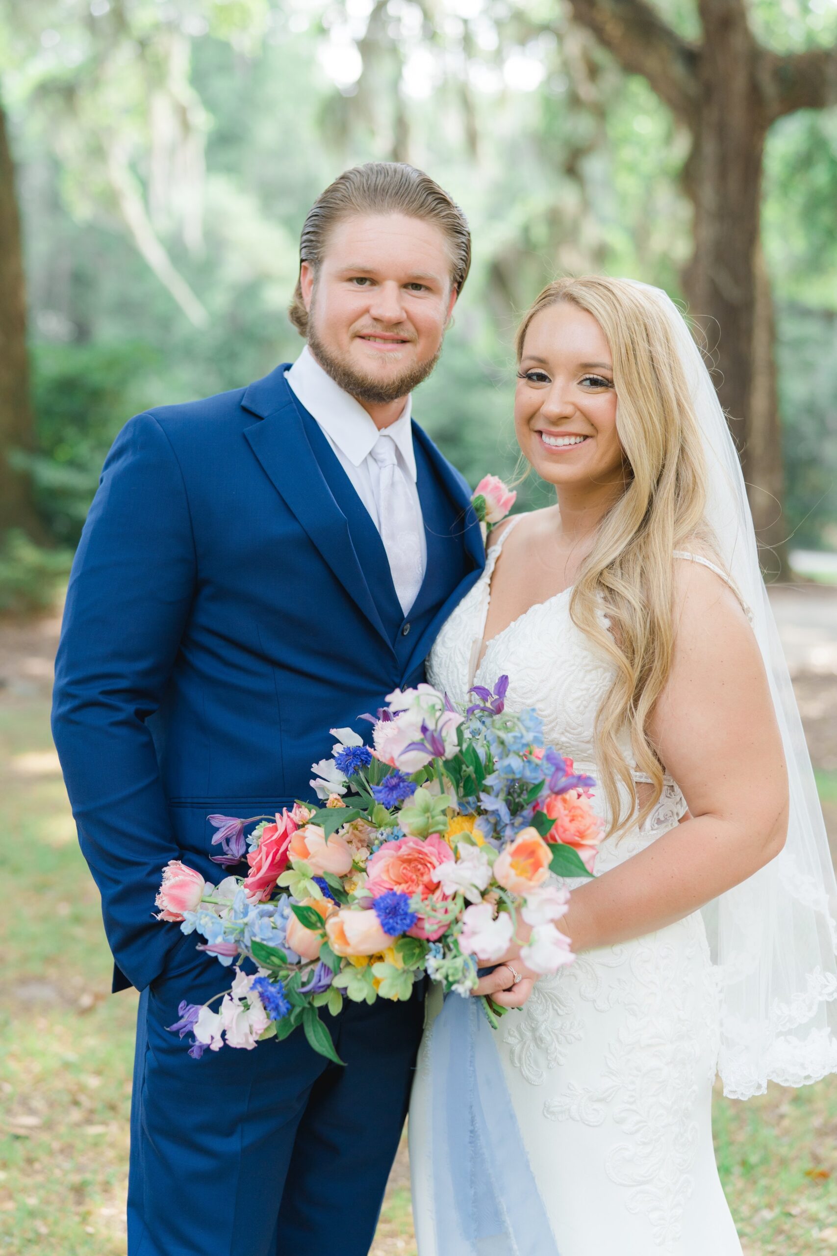 bride and groom with colorful wildflowers