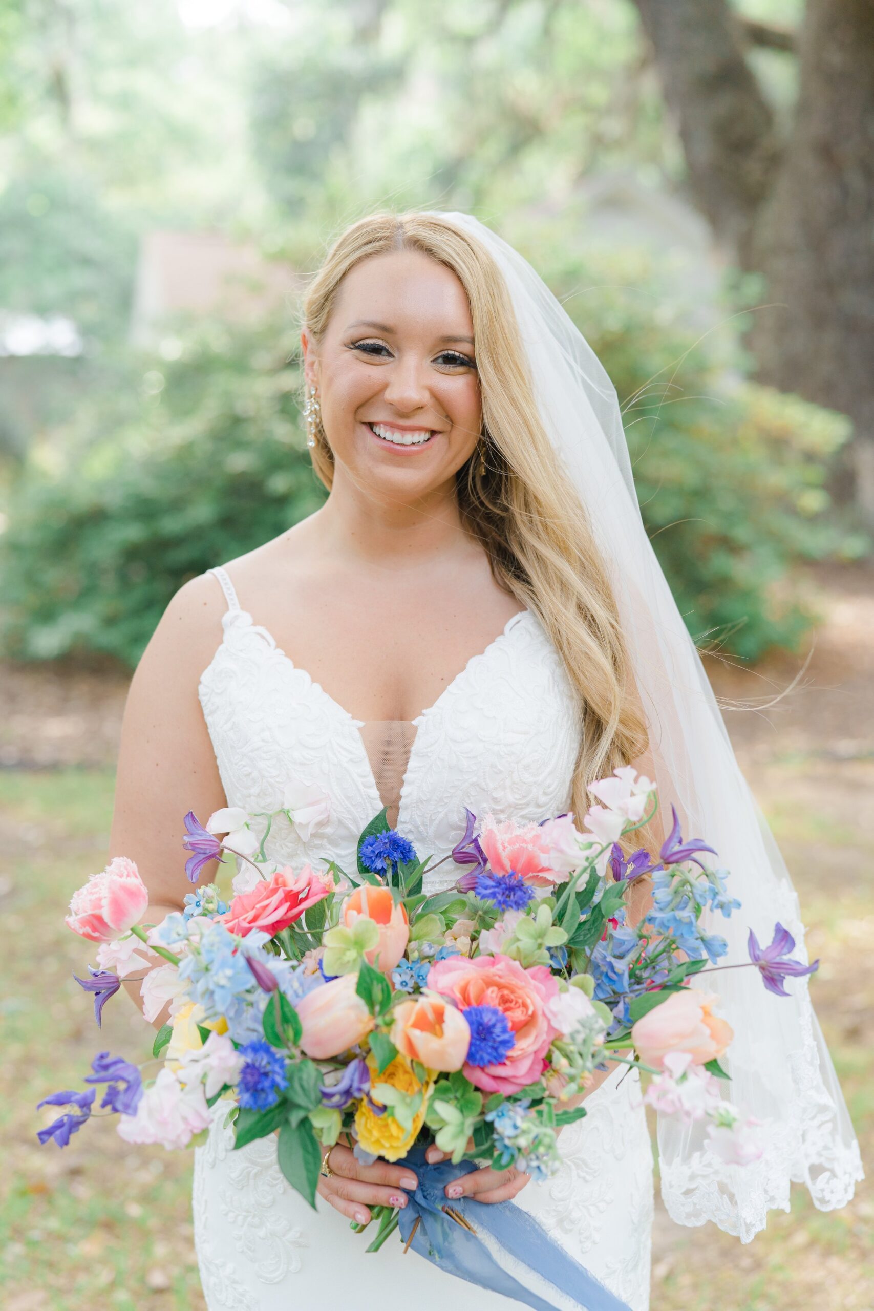 smiling bride with colorful spring flowers