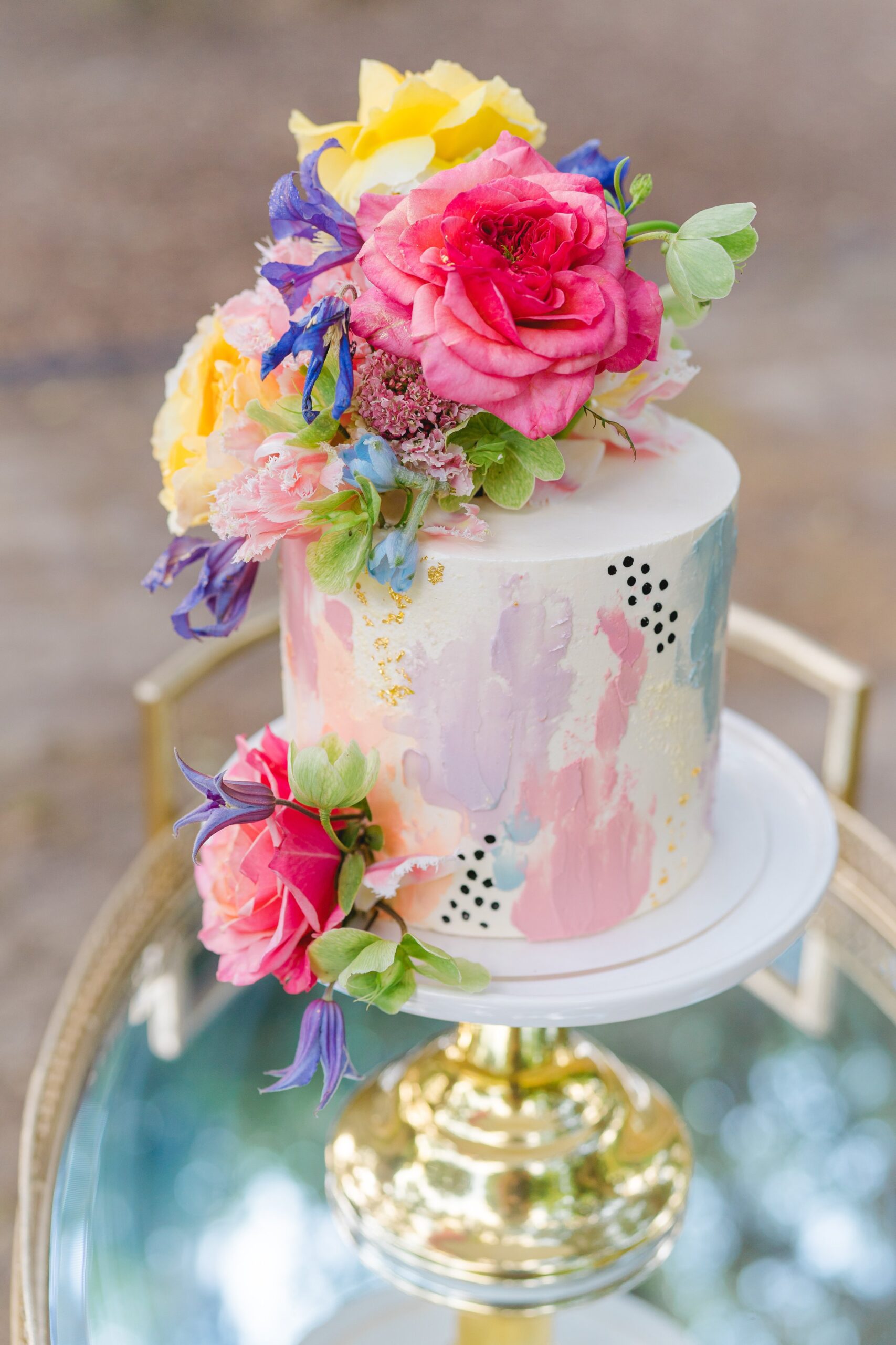 wildflower covered cake with black polkadots