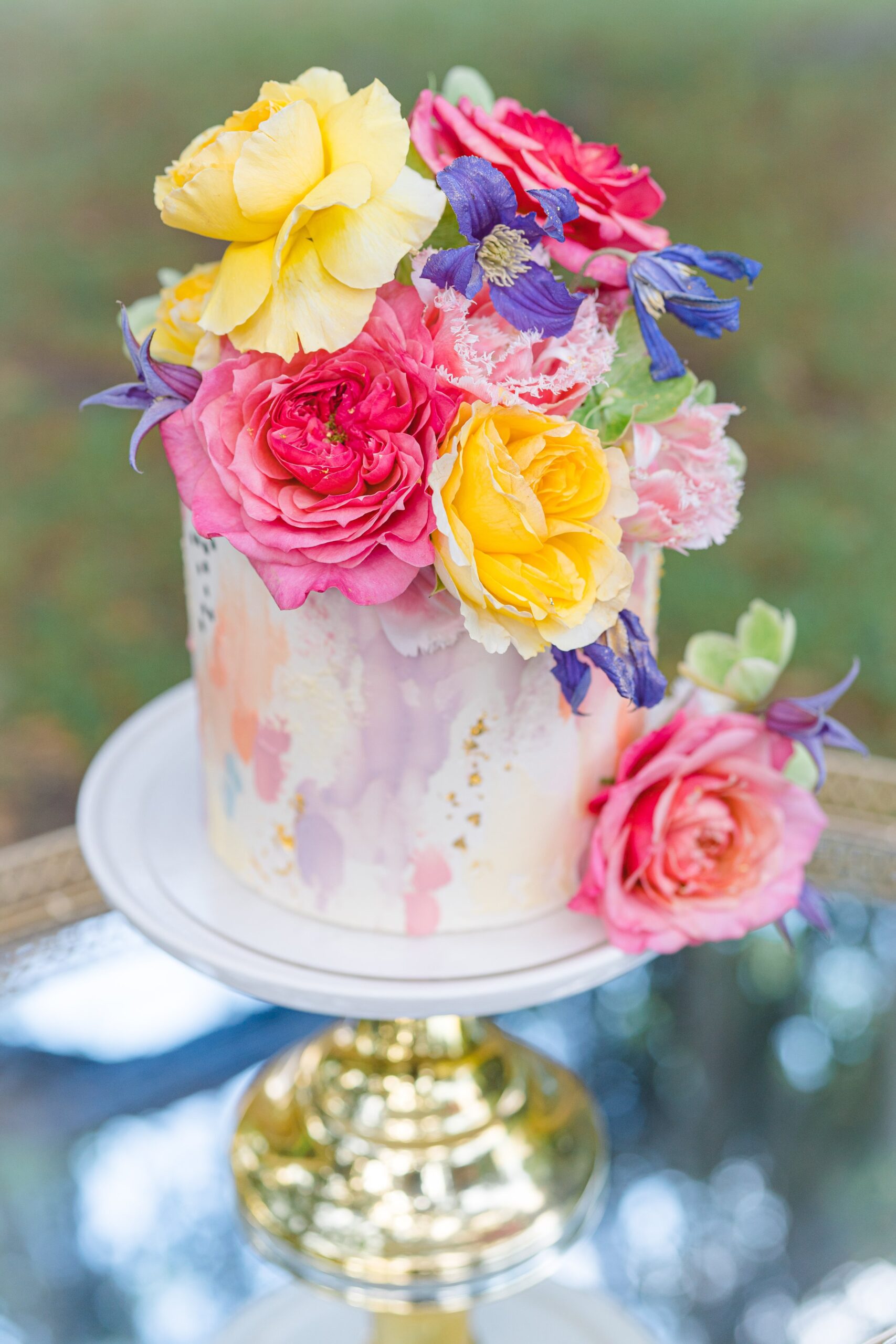 wedding cake with pink and yellow flowers