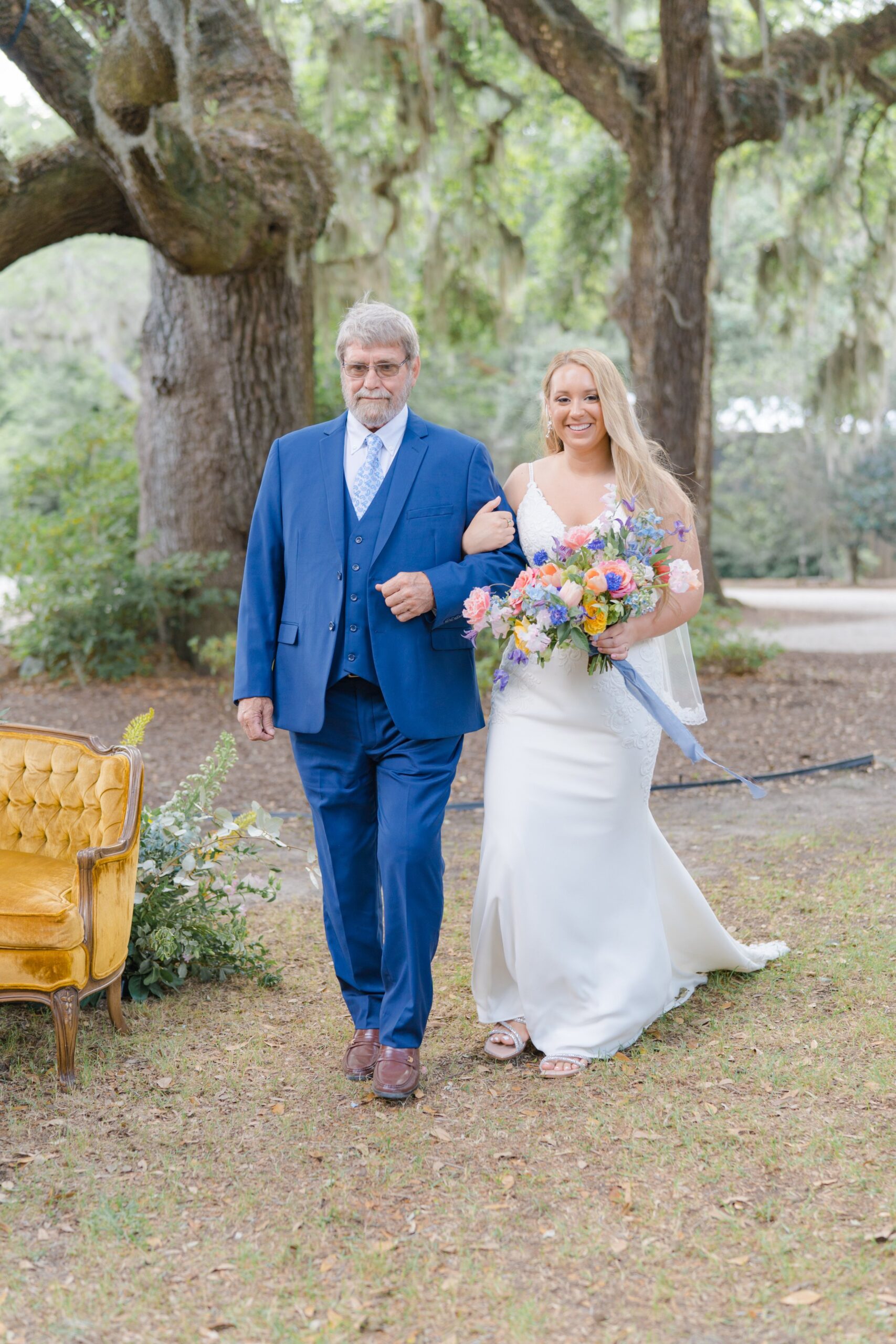 bride and dad walk up the aisle to intimate spring wedding ceremony