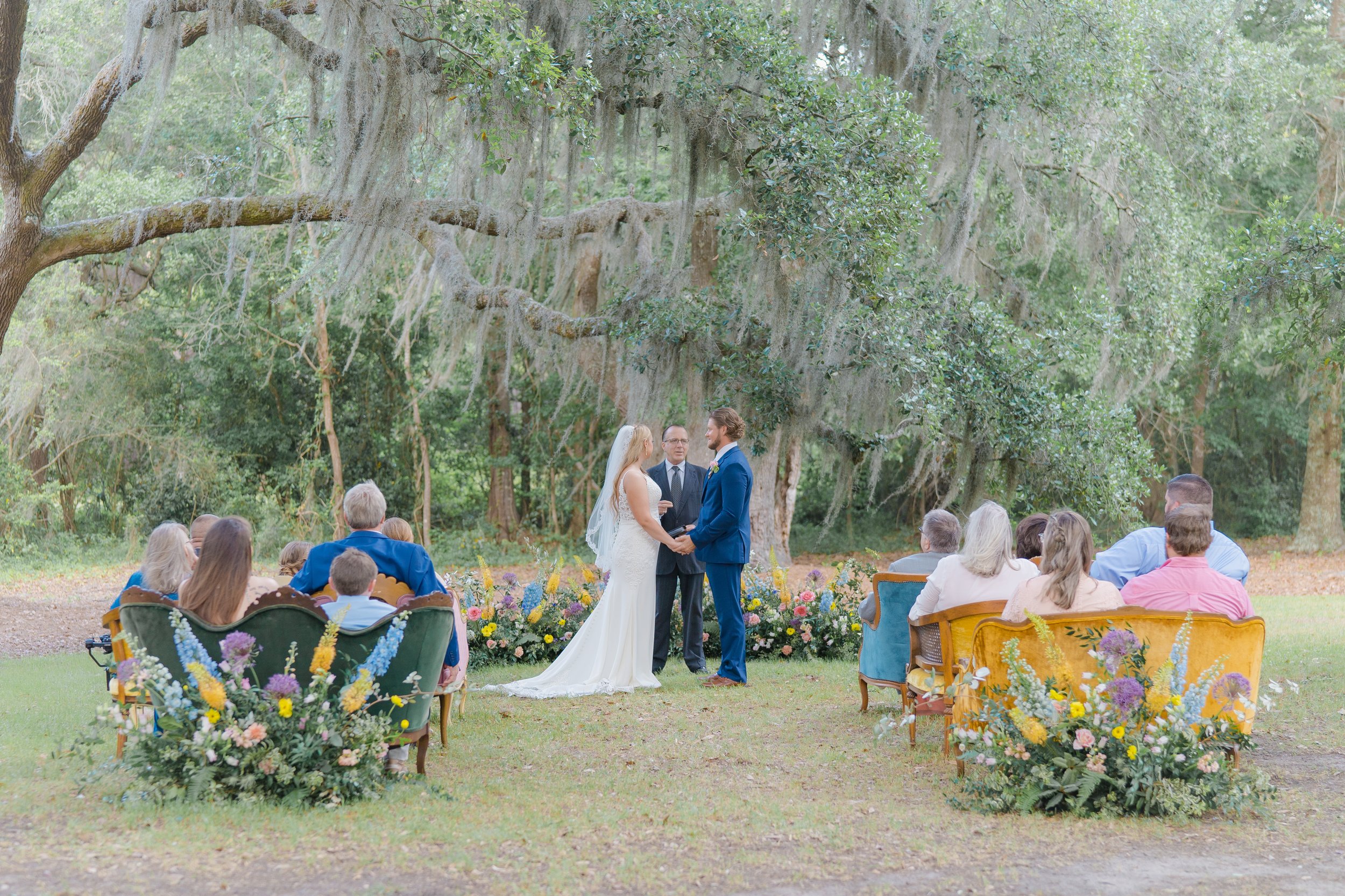 intimate spring wedding ceremony in charleston with colorful vintage couches