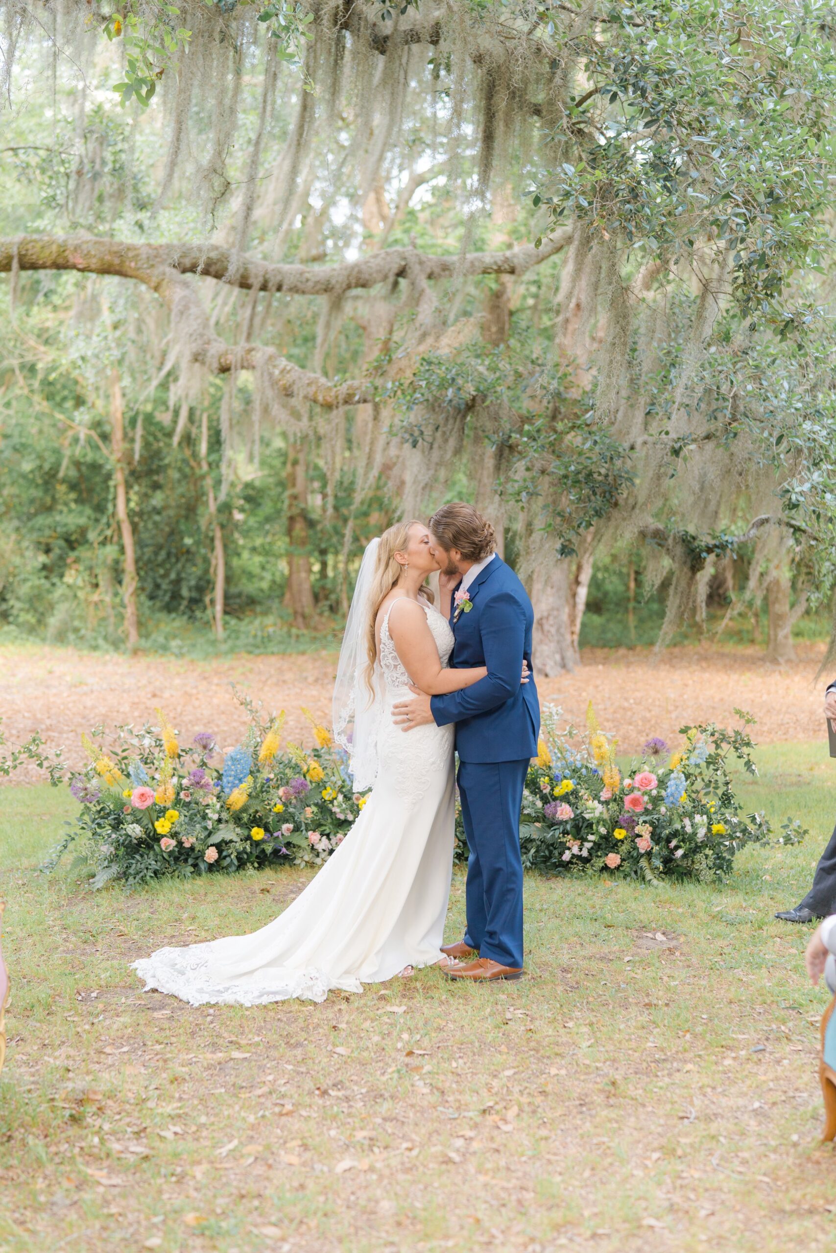 first kiss with colorful wildflowers and spanish moss