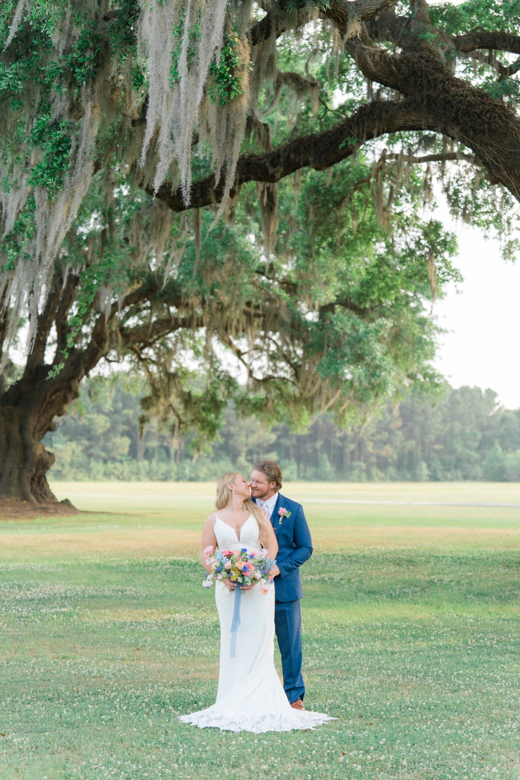 bride and groom with live oak trees and spanish moss