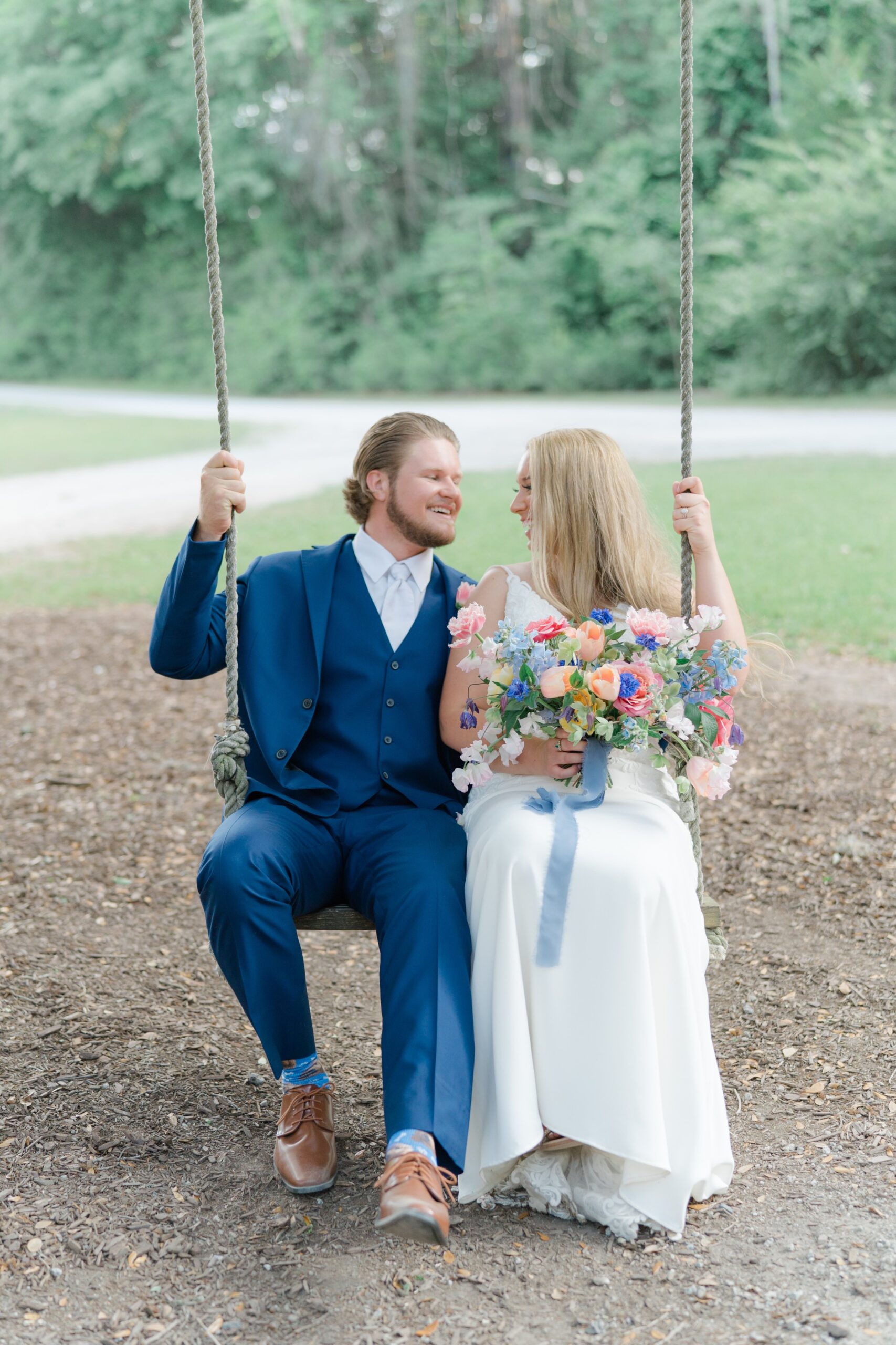 happy bride and groom on rope swing