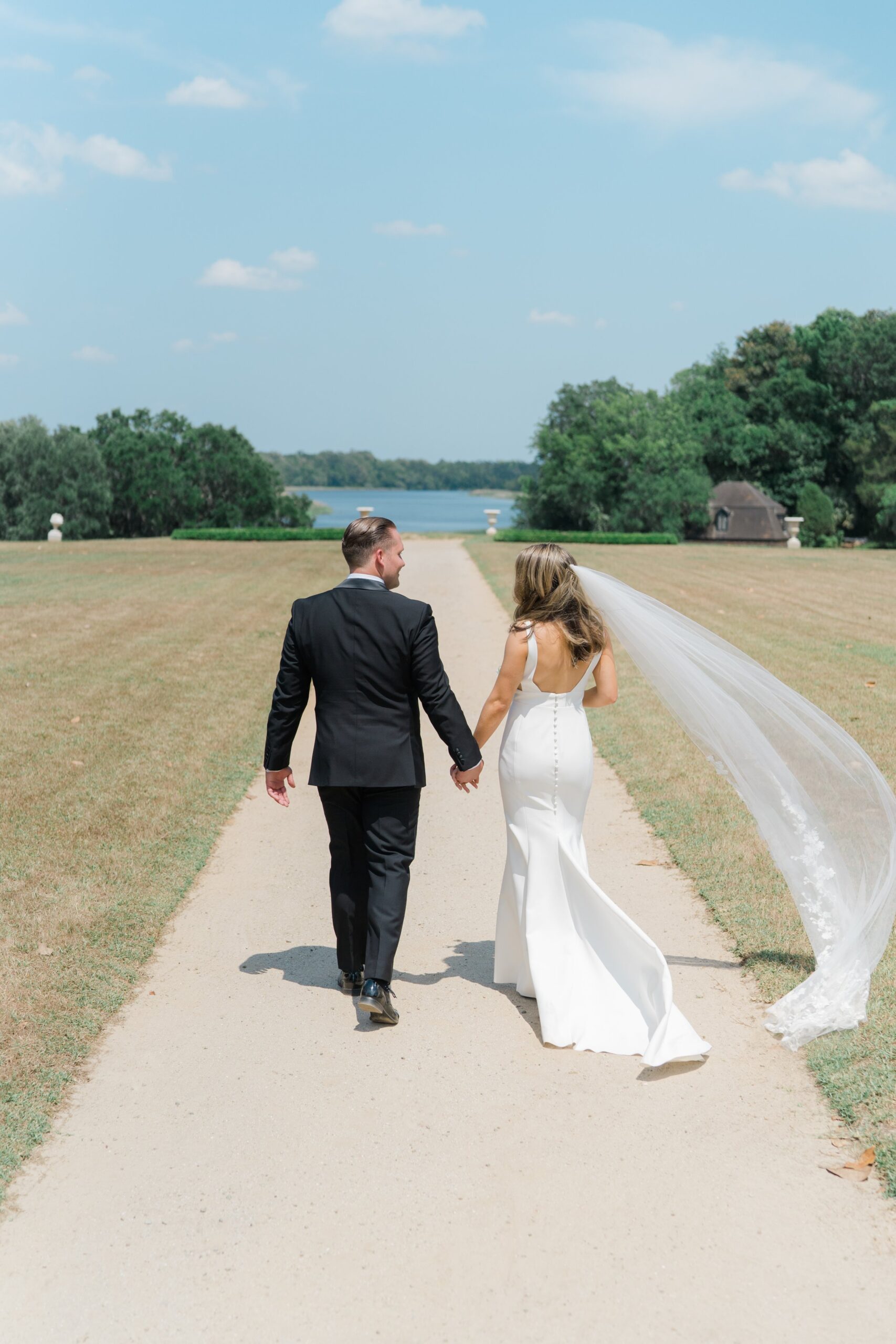 Bride and groom walk away to butterfly gardens at Middleton Place spring wedding.