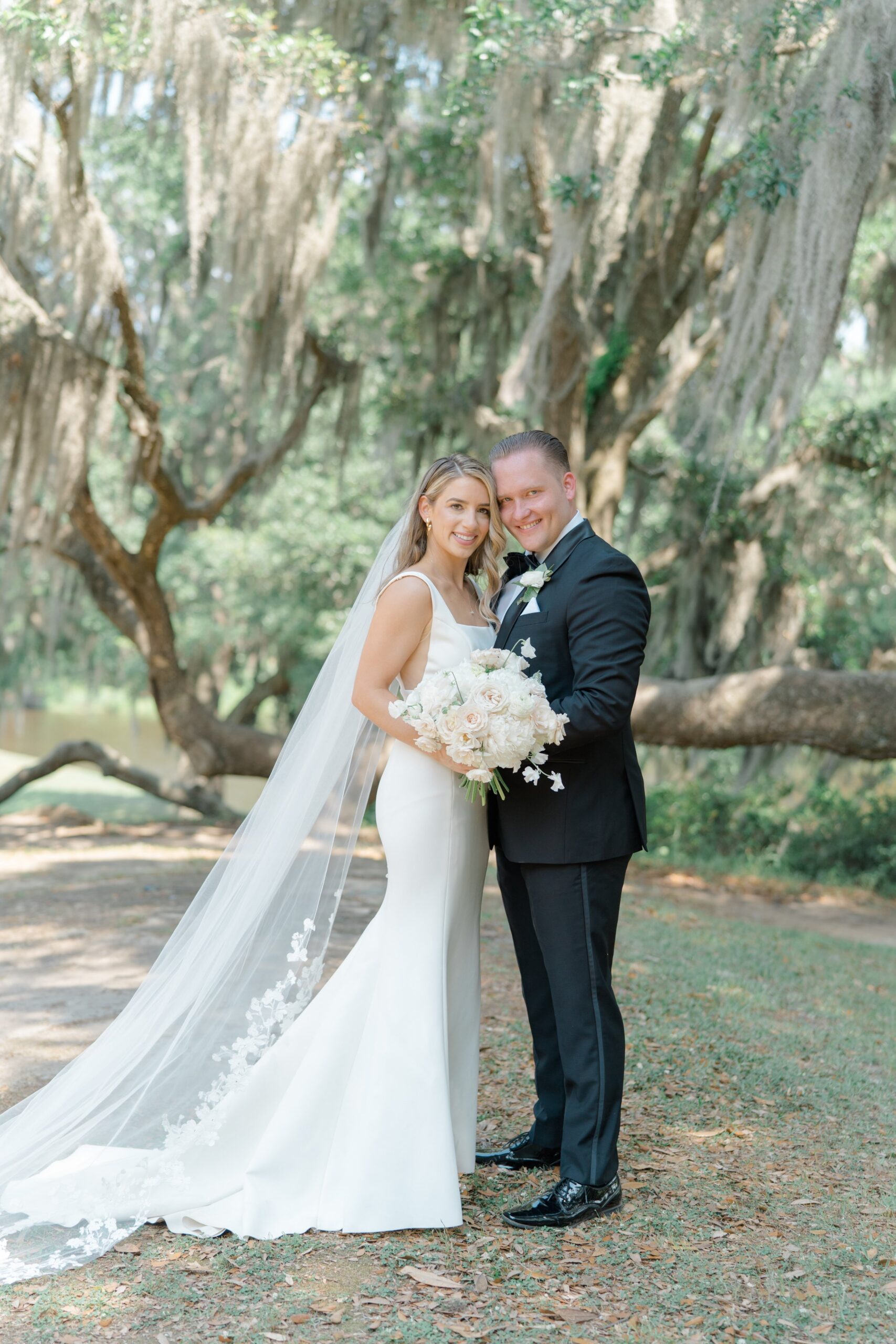 Bride and groom with spanish moss. Charleston wedding photographer.
