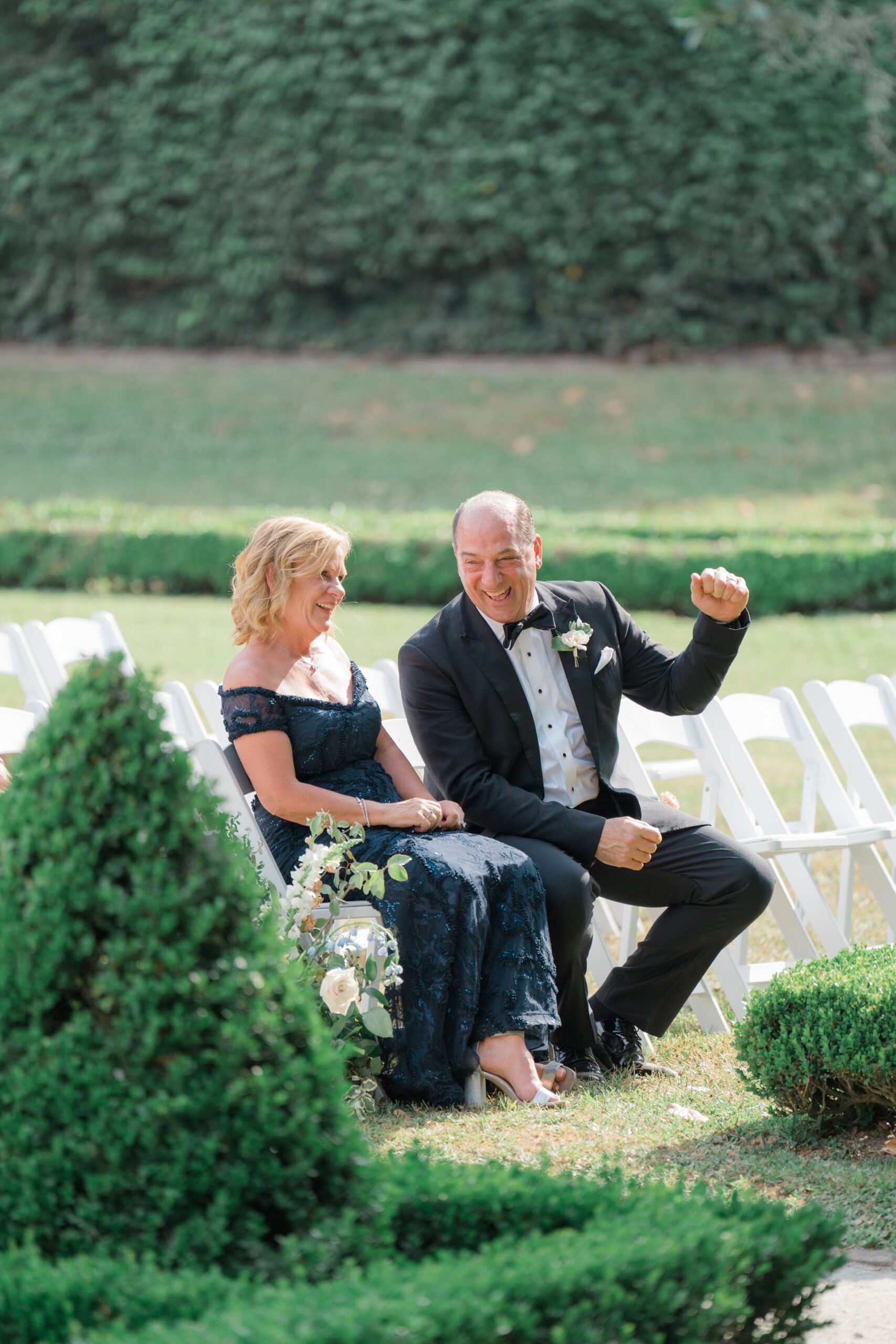 Parents of the bride celebrate during outdoor wedding ceremony in Charleston