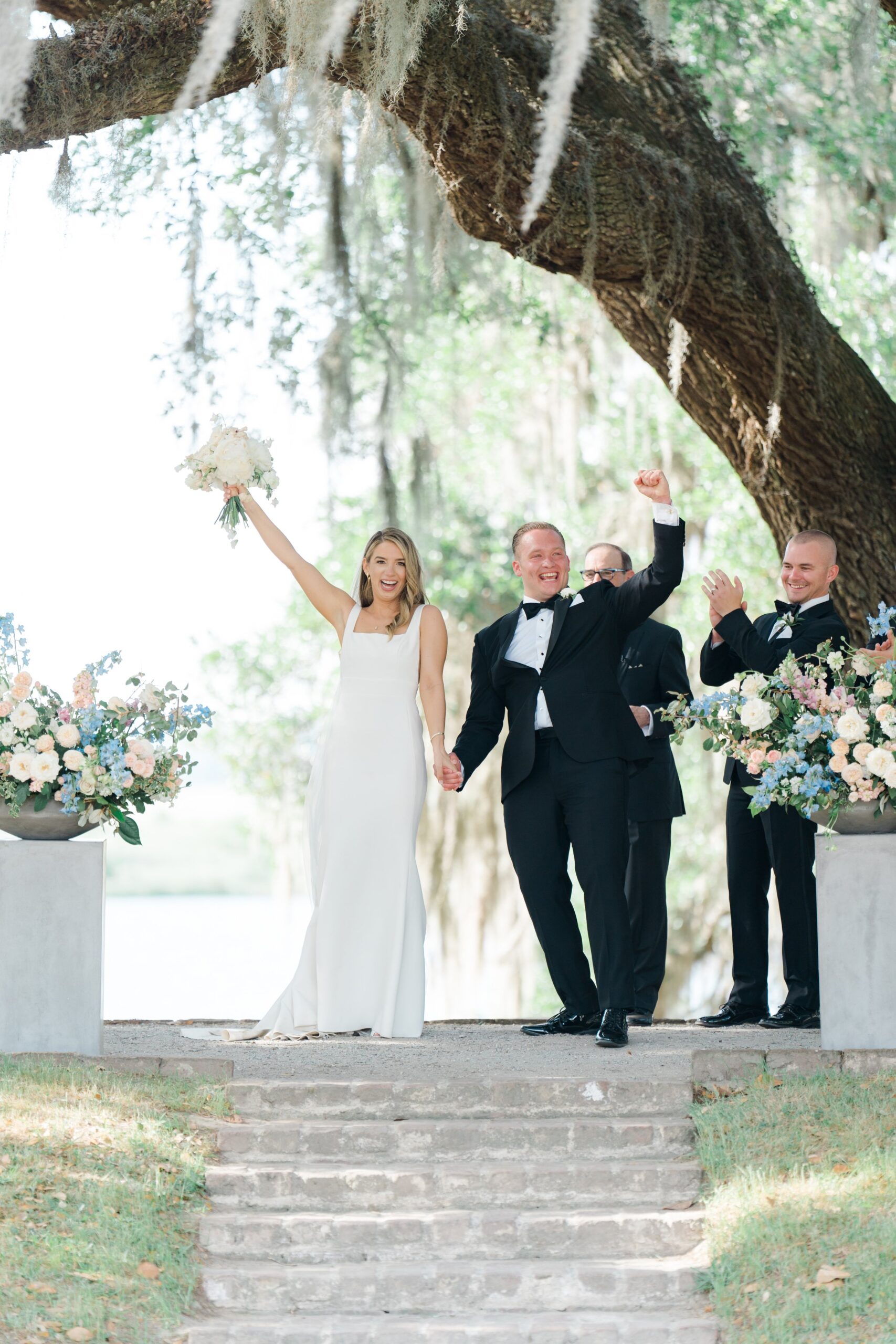Bride and groom celebrate after first kiss. Charleston spring wedding.
