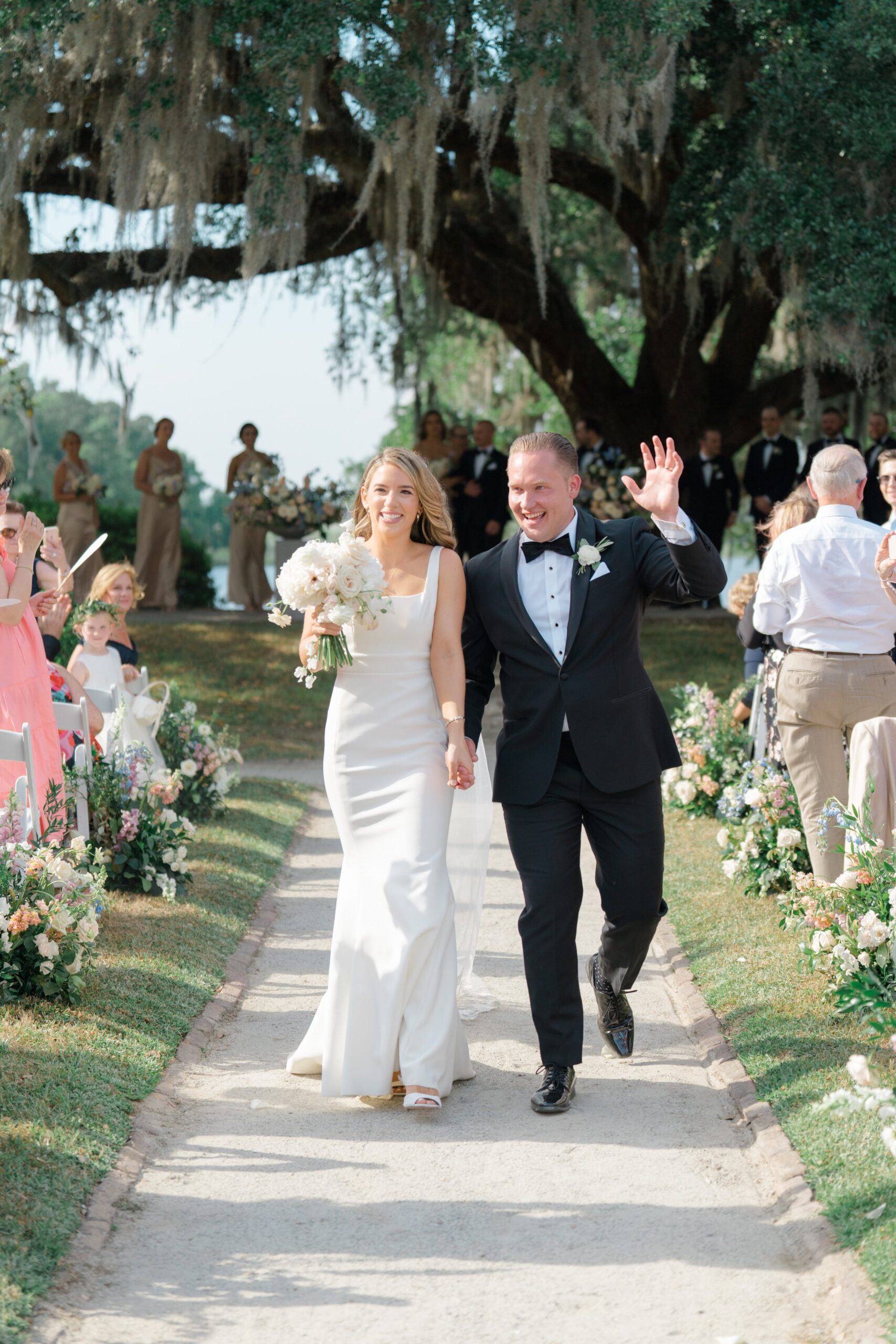 Newlyweds walk down the aisle at octagonal garden. East Coast Destination Wedding Photographer