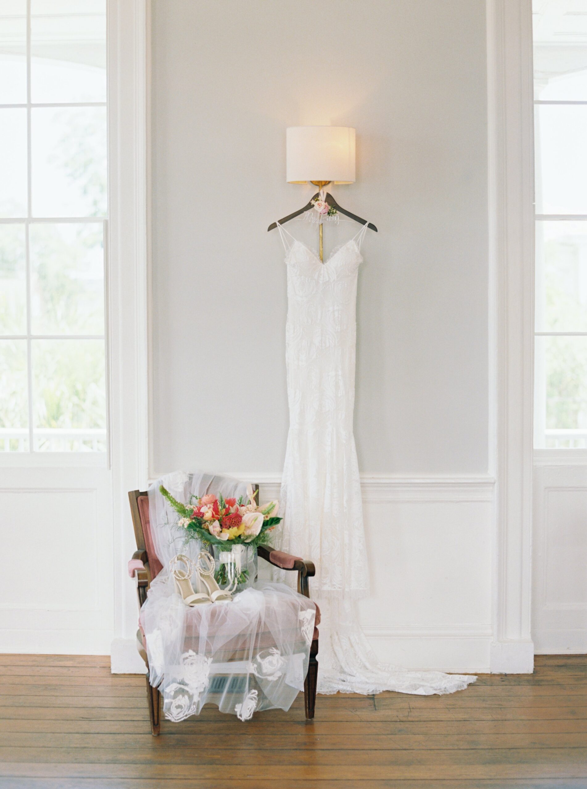 Wedding dress hanging in Gadsden House Charleston wedding venue.