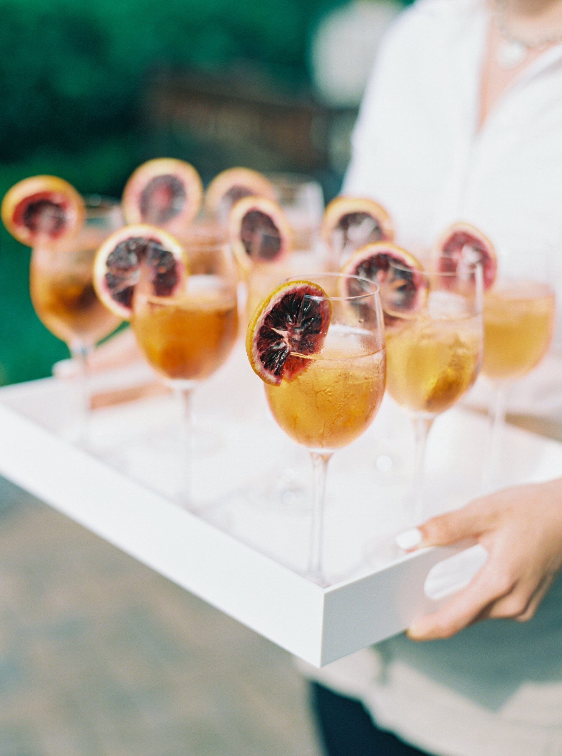 Tray of blood orange cocktails at outdoor spring wedding in Charleston.