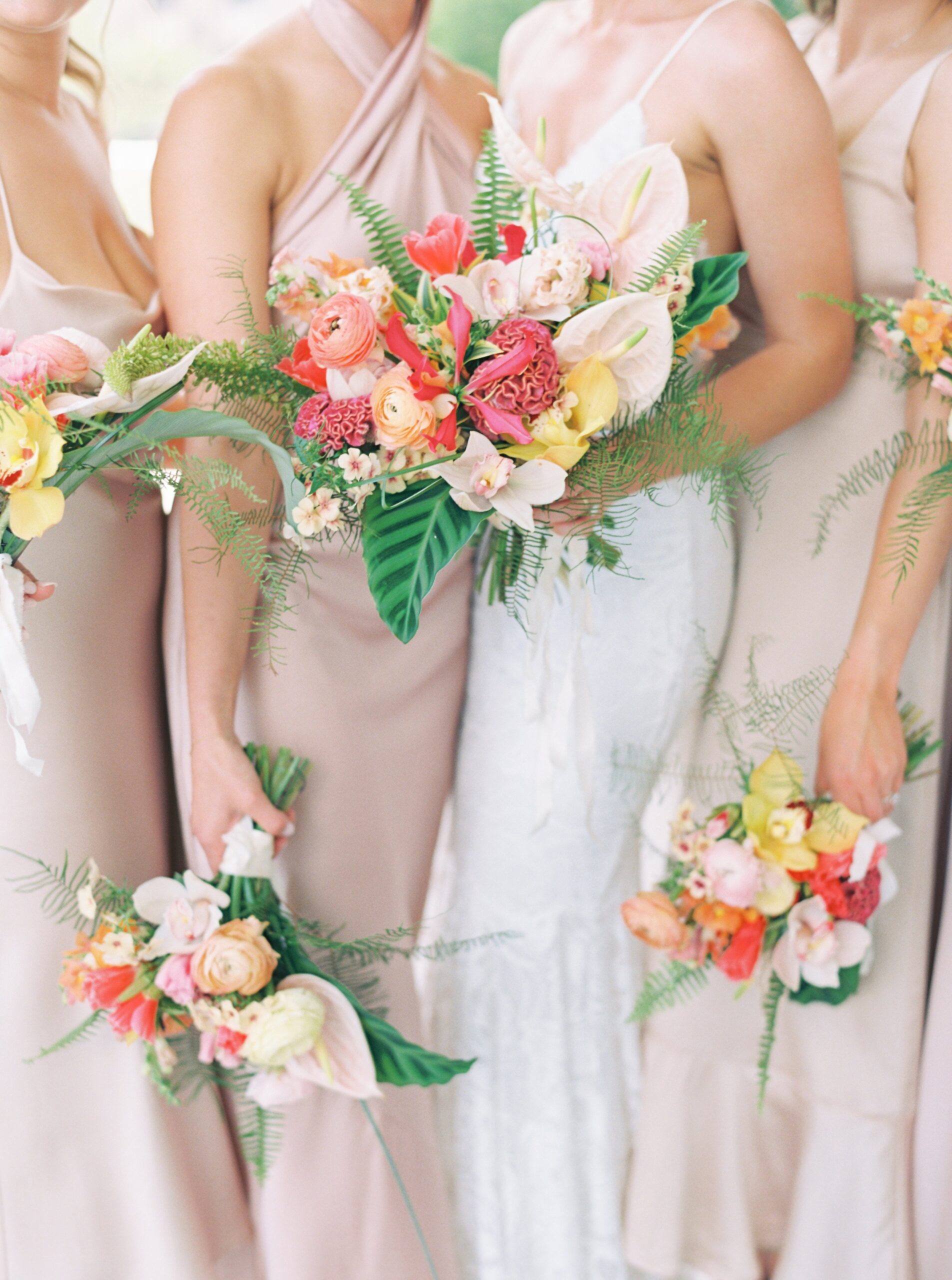 Bride and bridesmaids bright and tropical bouquet.
