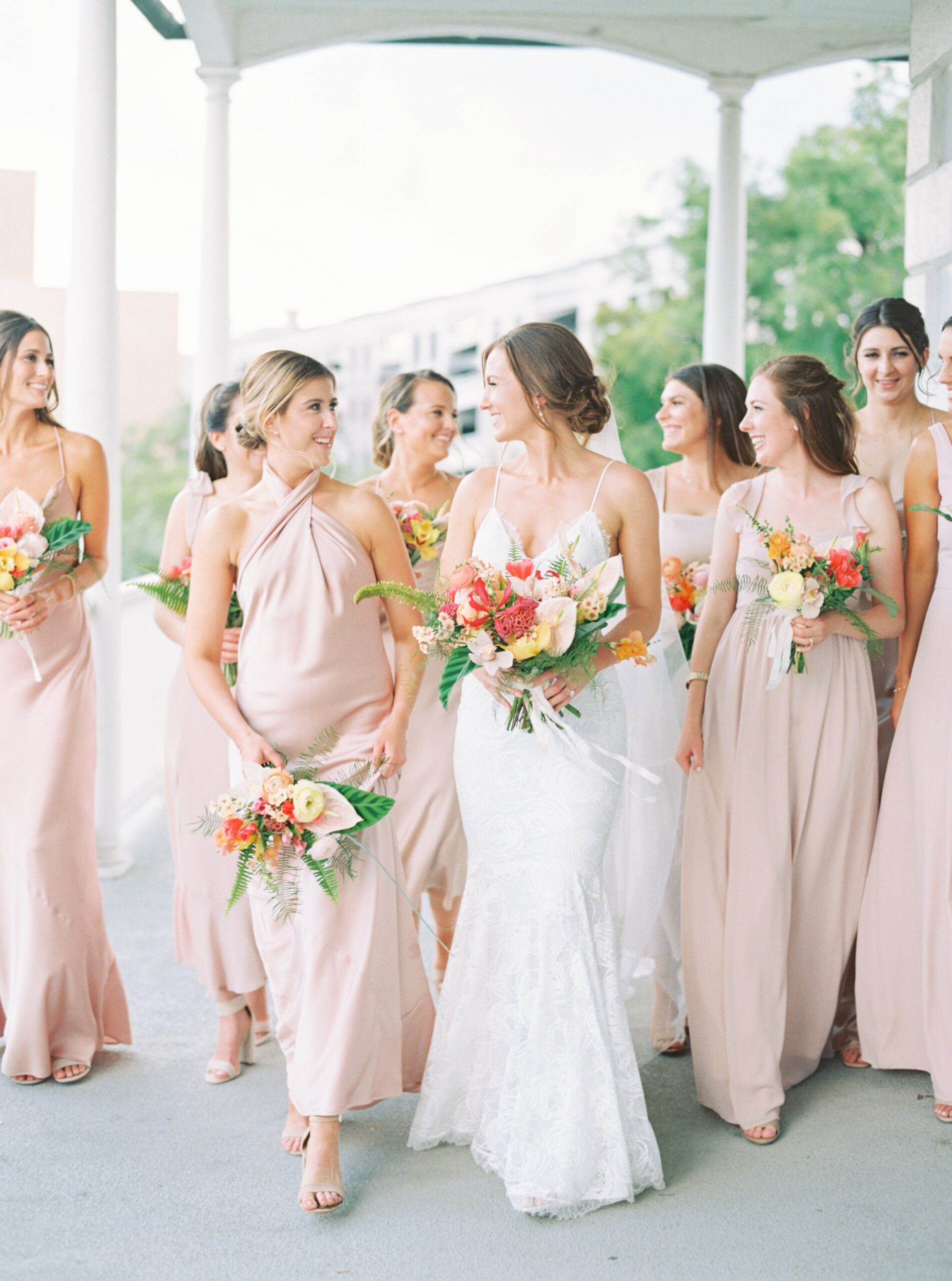 Bride walks with bridesmaids on the porch at Gadsden House.