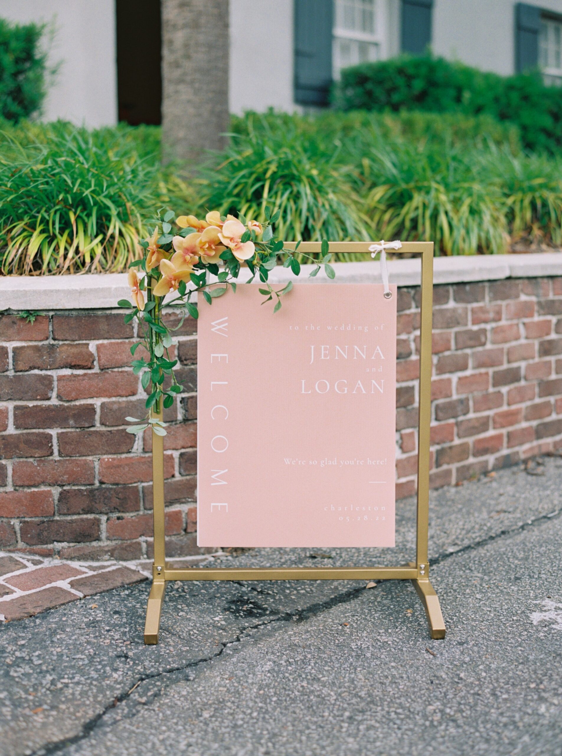 Pale pink wedding day welcome sign with flowers.