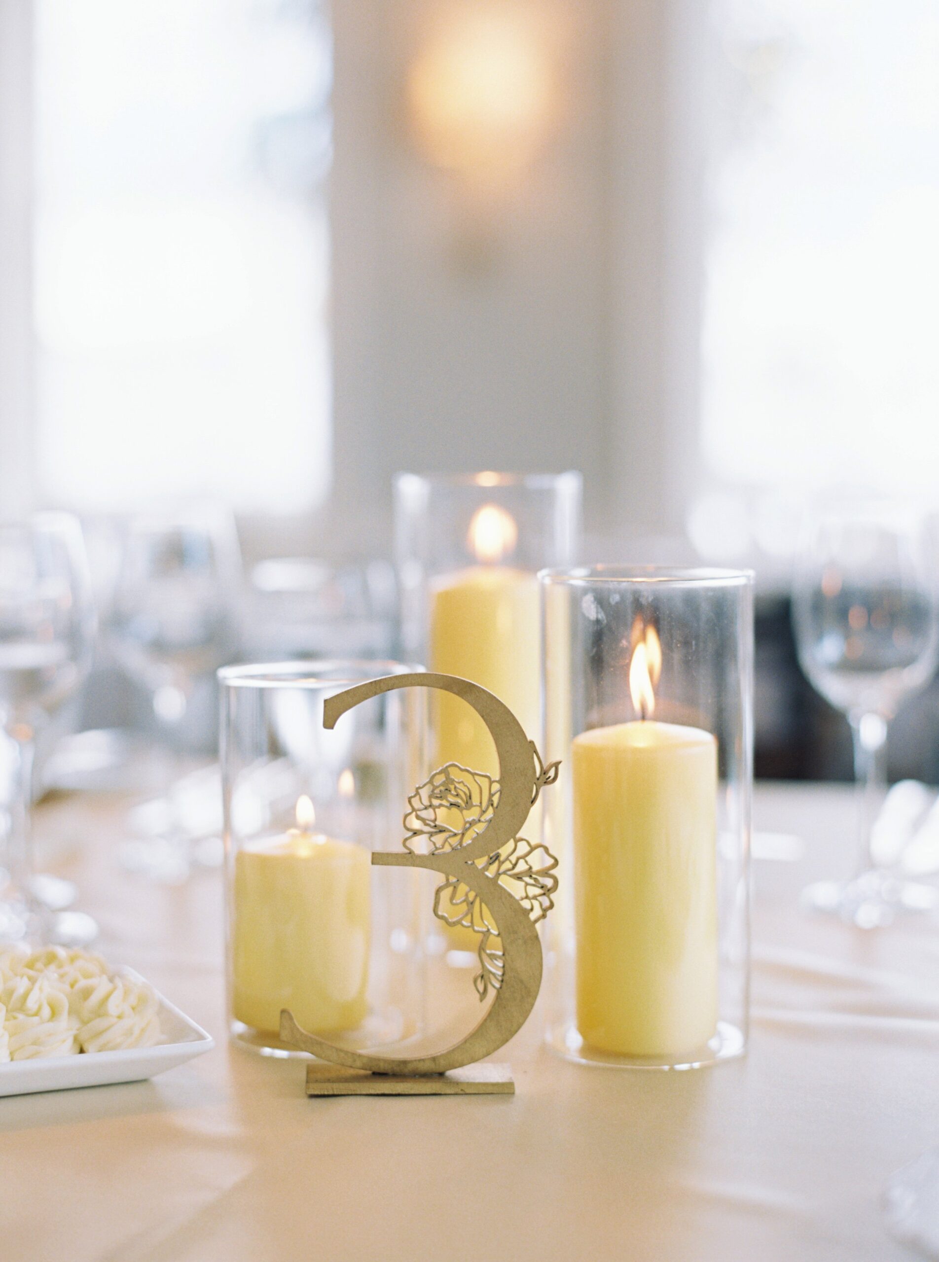 yellow candle and gold number reception table set up.