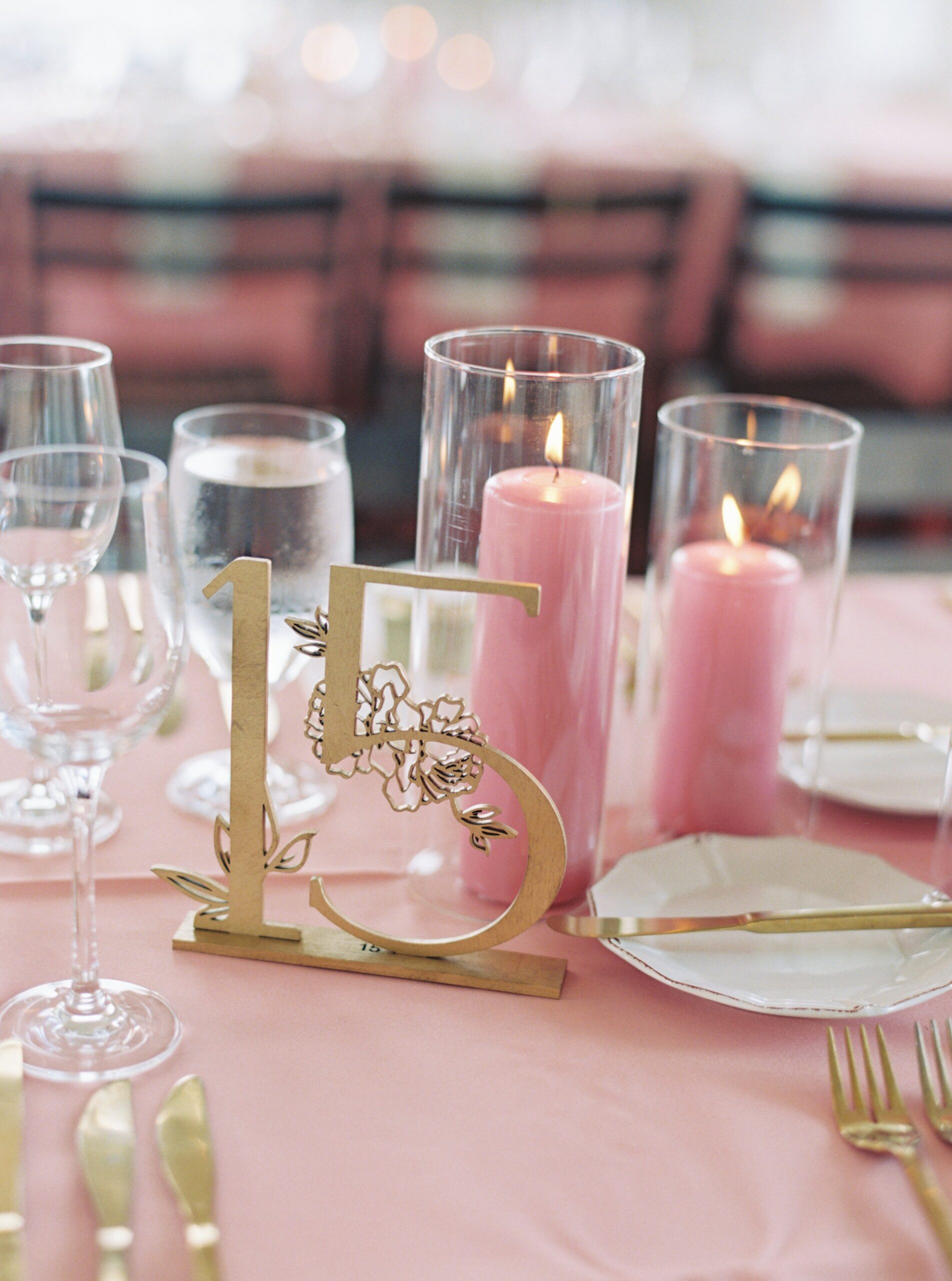 Pink table cloth with gold table numbers at Gadsden House wedding reception.