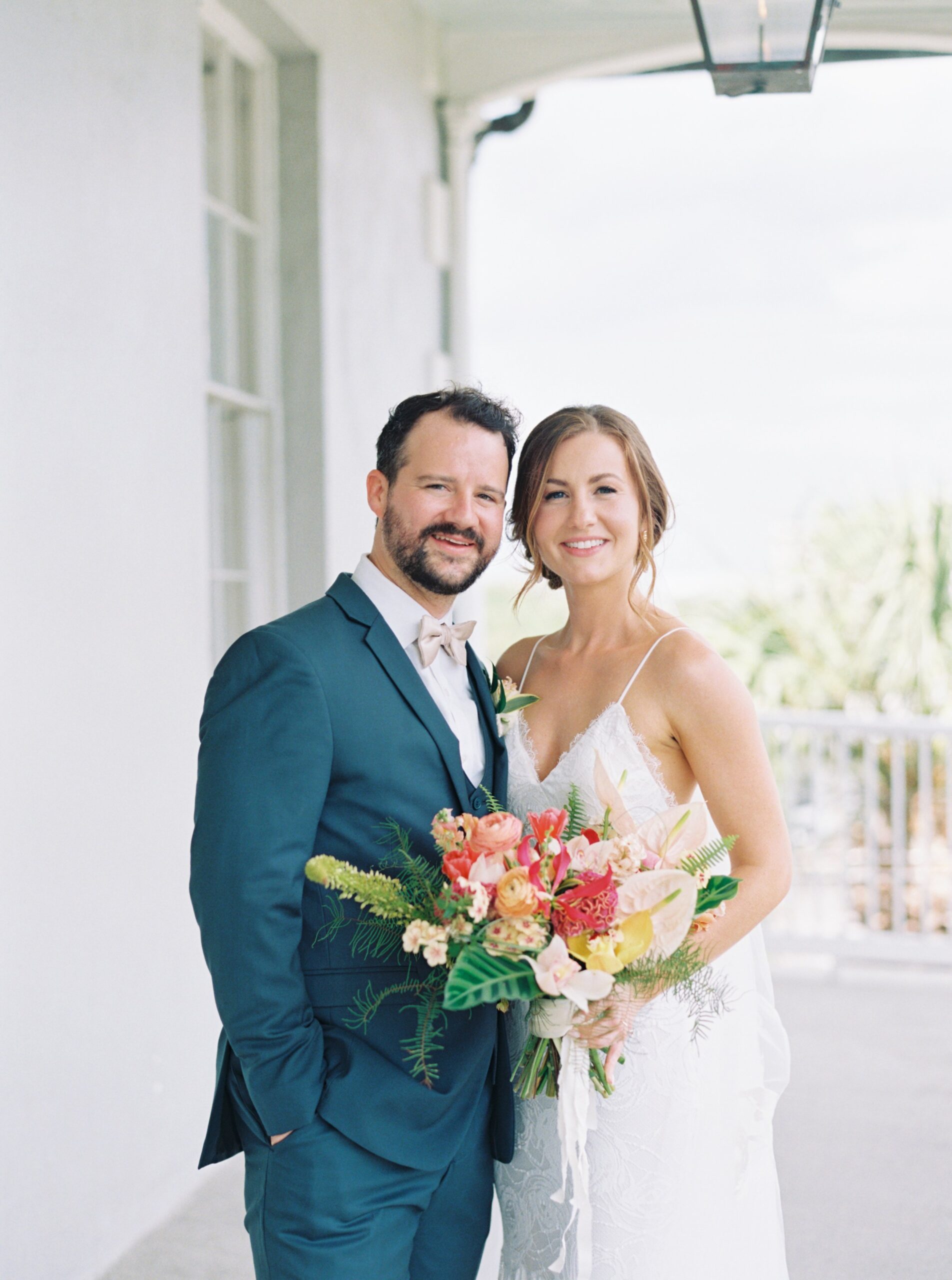 Charleston spring bride and groom. Tropical bridal flowers and groom in three piece suit.
