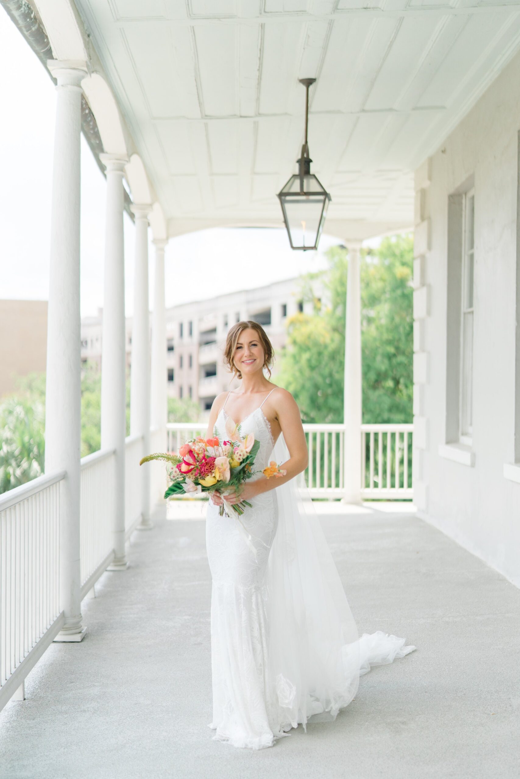 Bride standing on the porch at Gadsden House in Charleston.