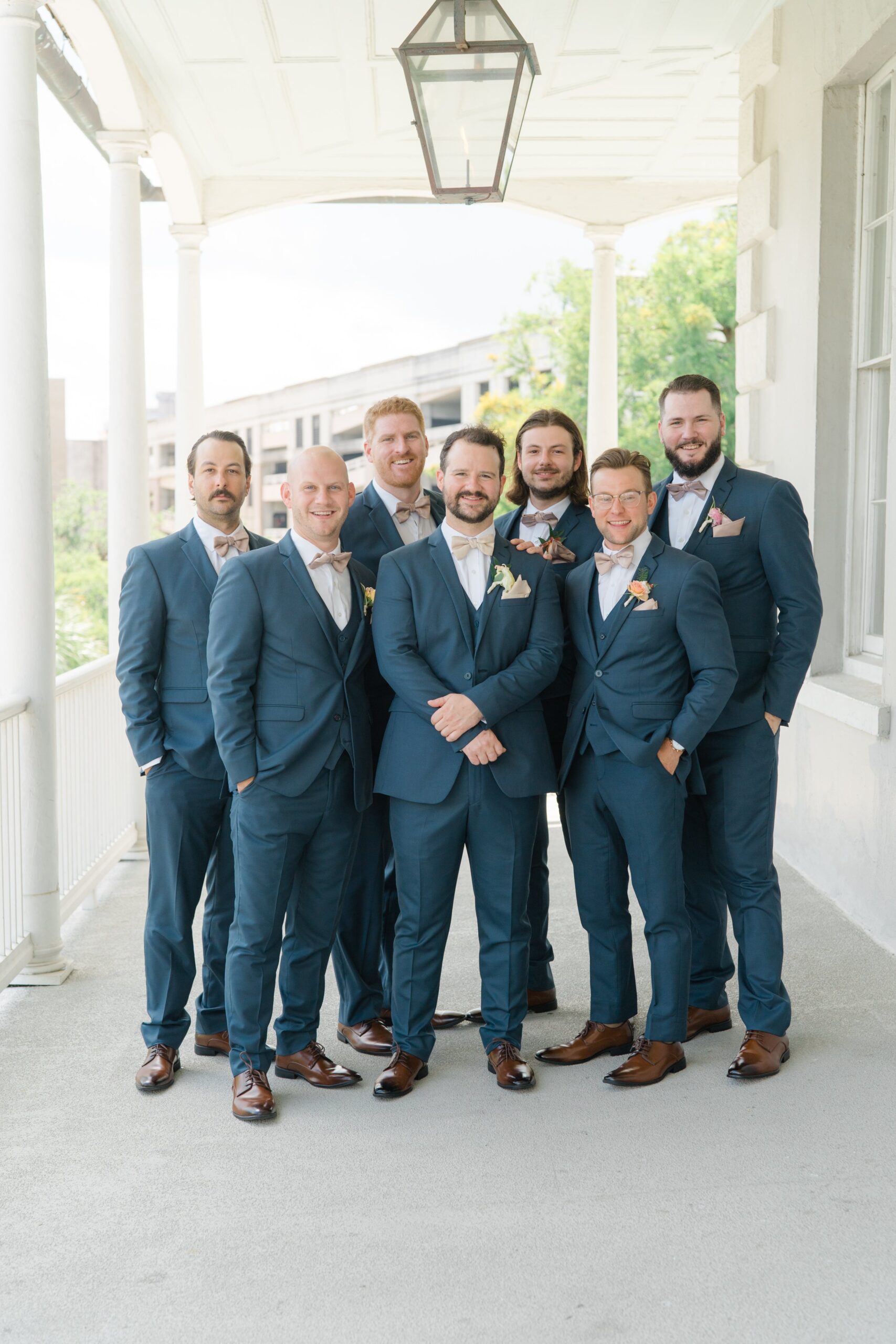 Groom and groomsmen on the porch at Gadsden House.