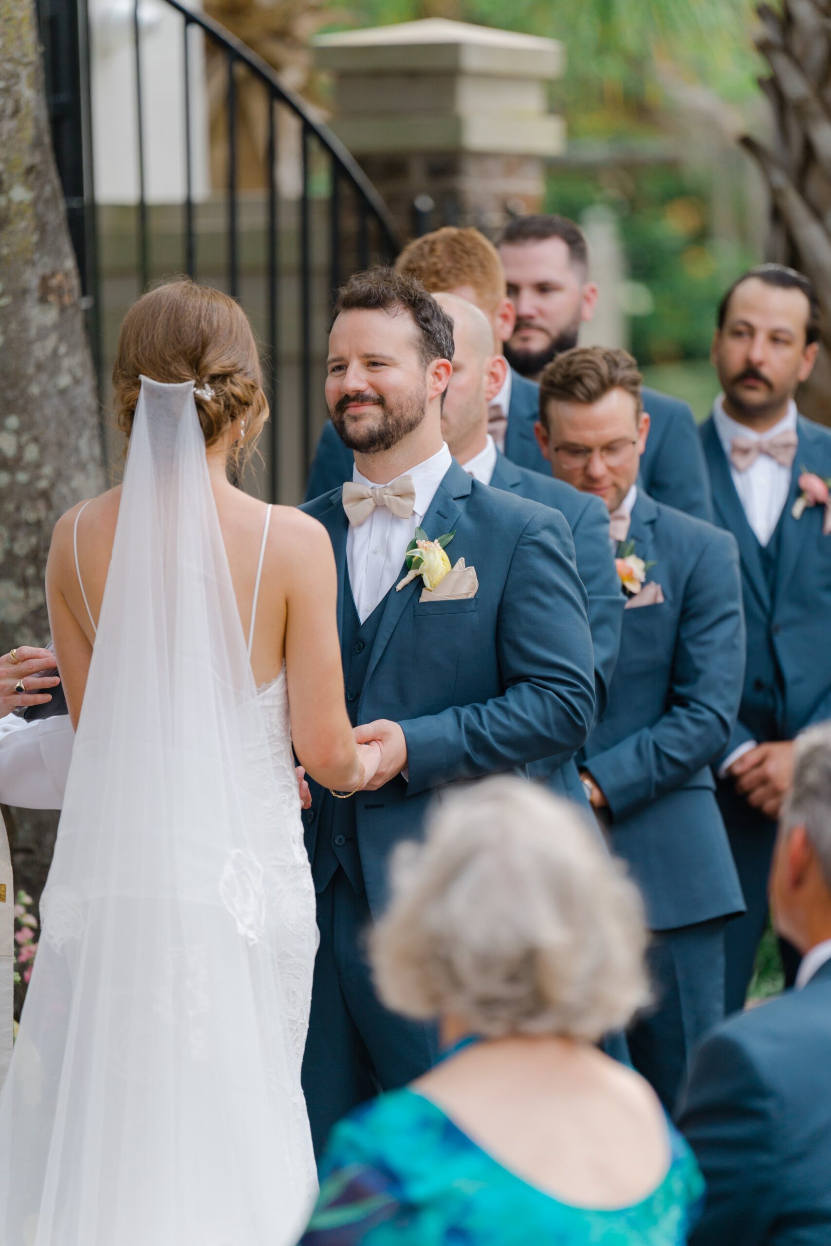 Groom looks at bride during outdoor spring wedding.