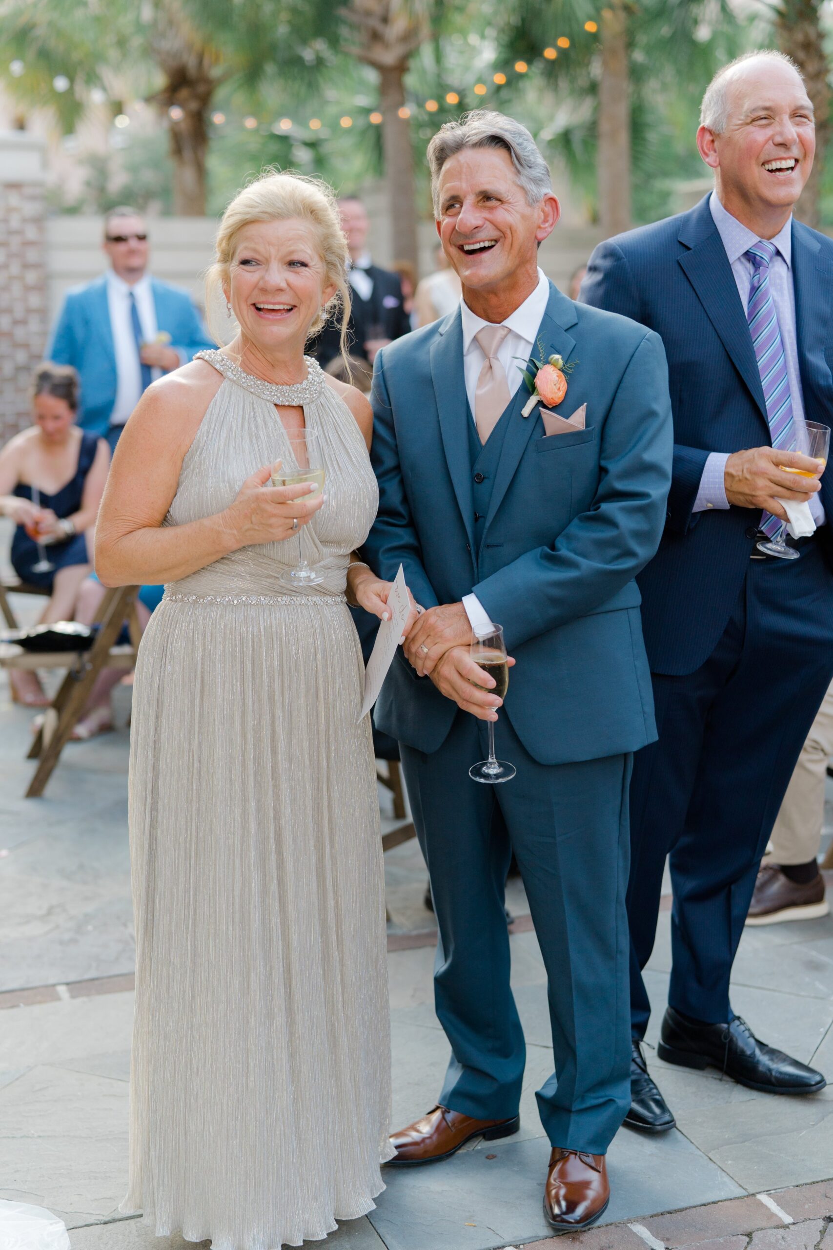 Parents of the groom laugh during wedding reception.