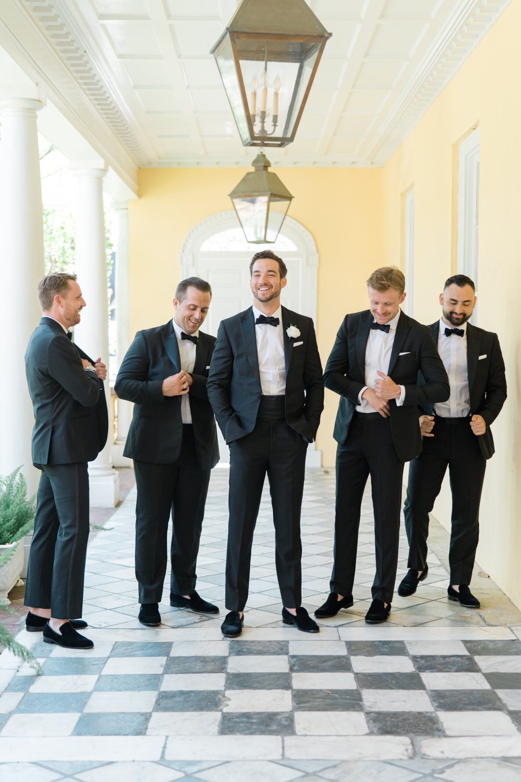 Groom hanging out with groomsmen. Candid Charleston wedding photos.