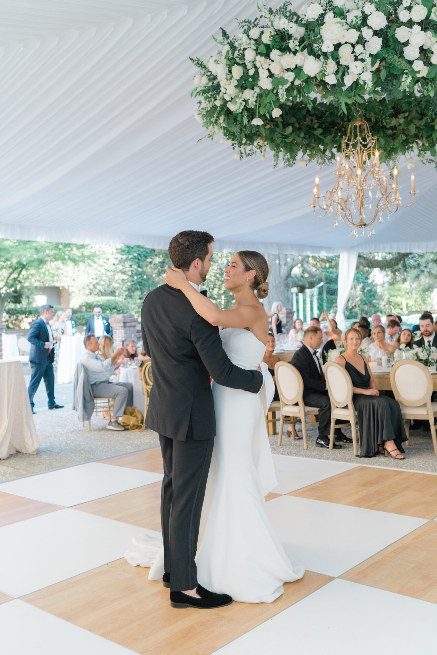 Tented outdoor wedding reception bride and groom first dance.