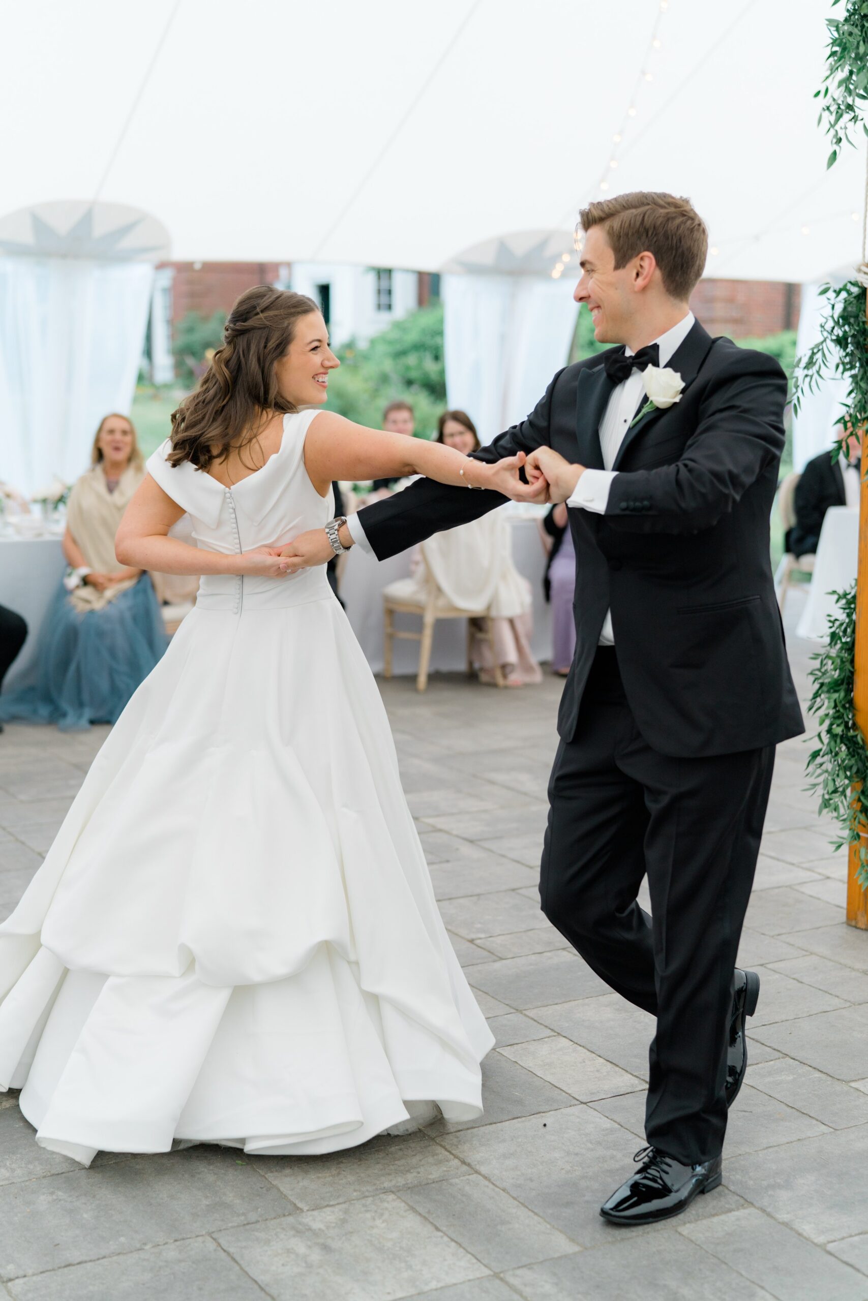 Bride and groom arms interlocked during boston summer wedding.