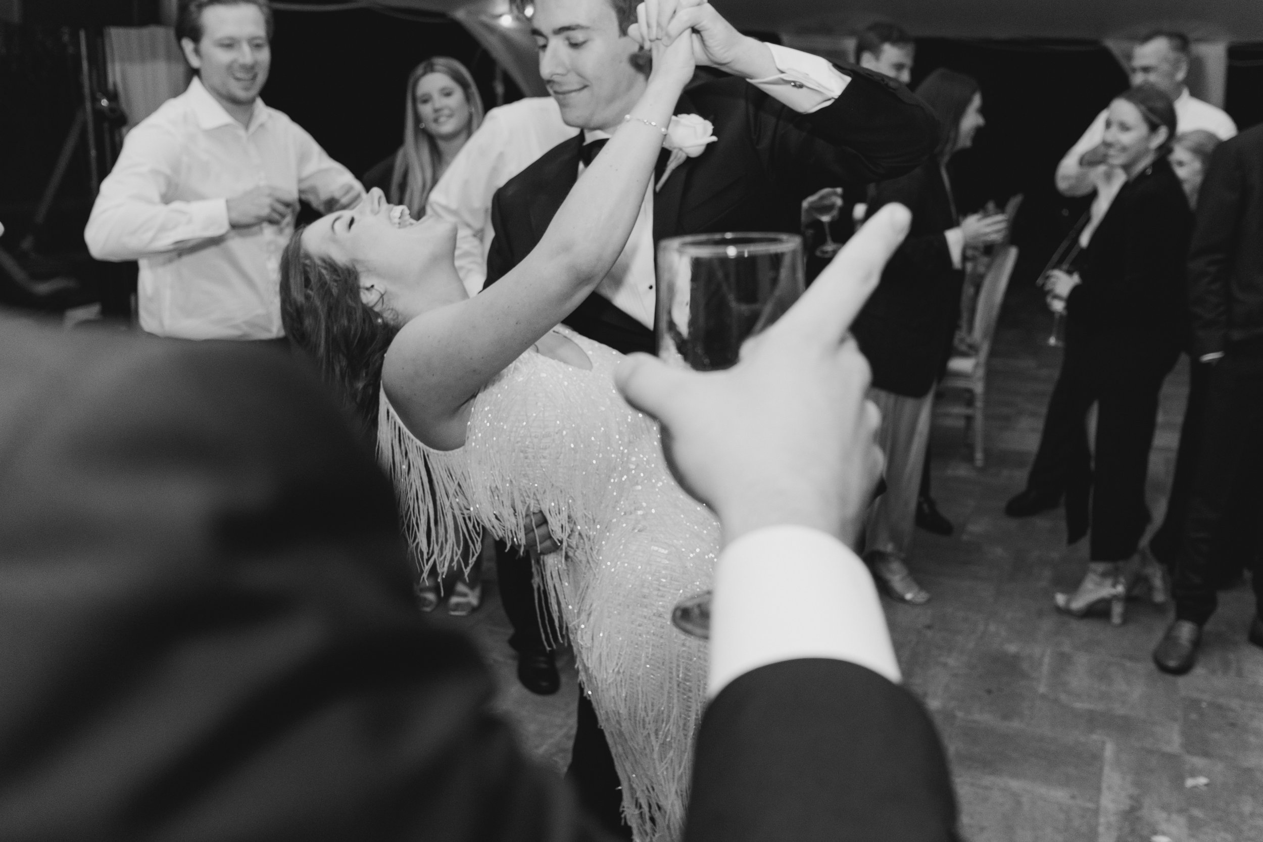 Black and white candid dance floor wedding photo.
