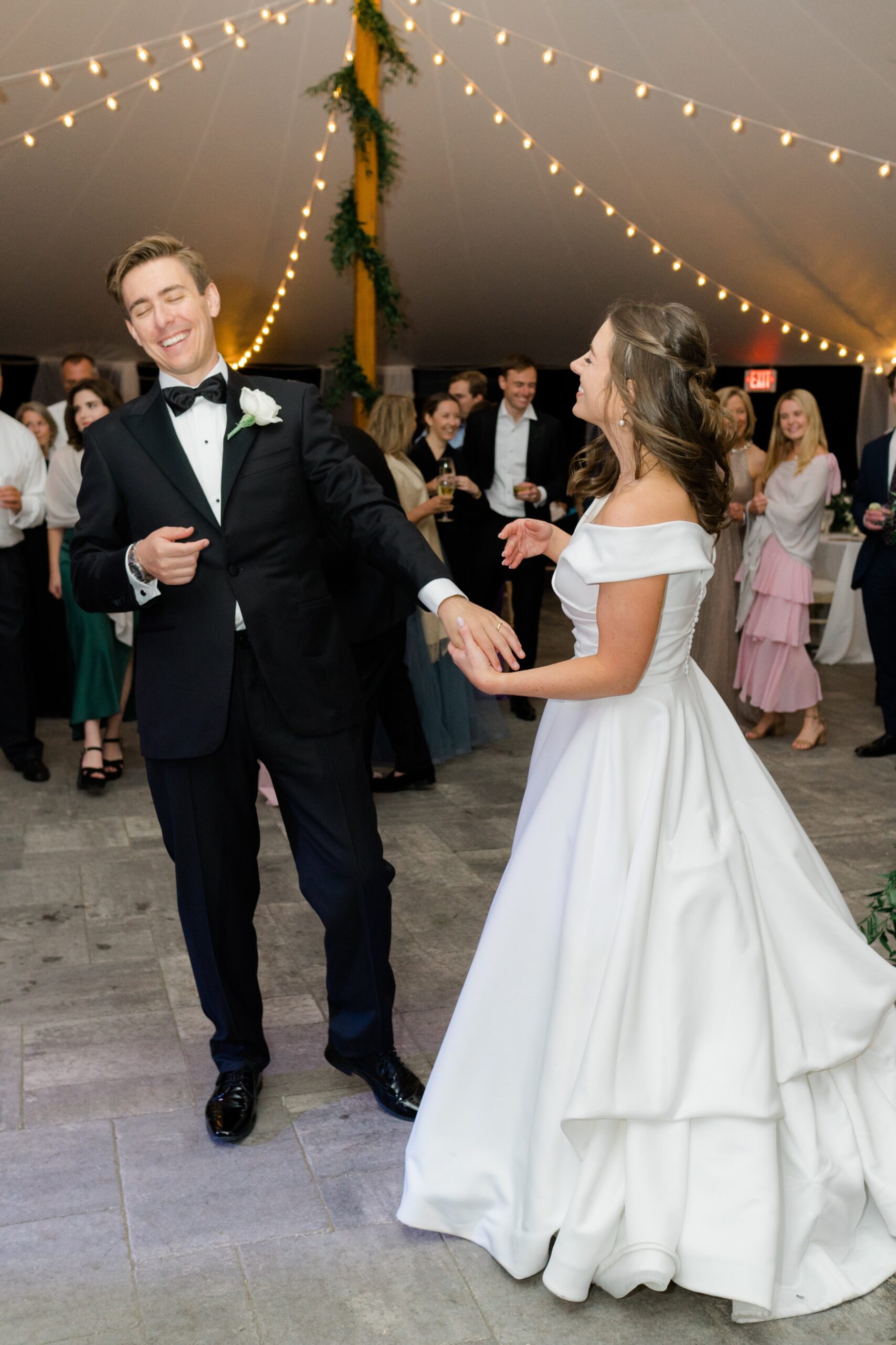 Bride and groom share fun moment on the dance floor.