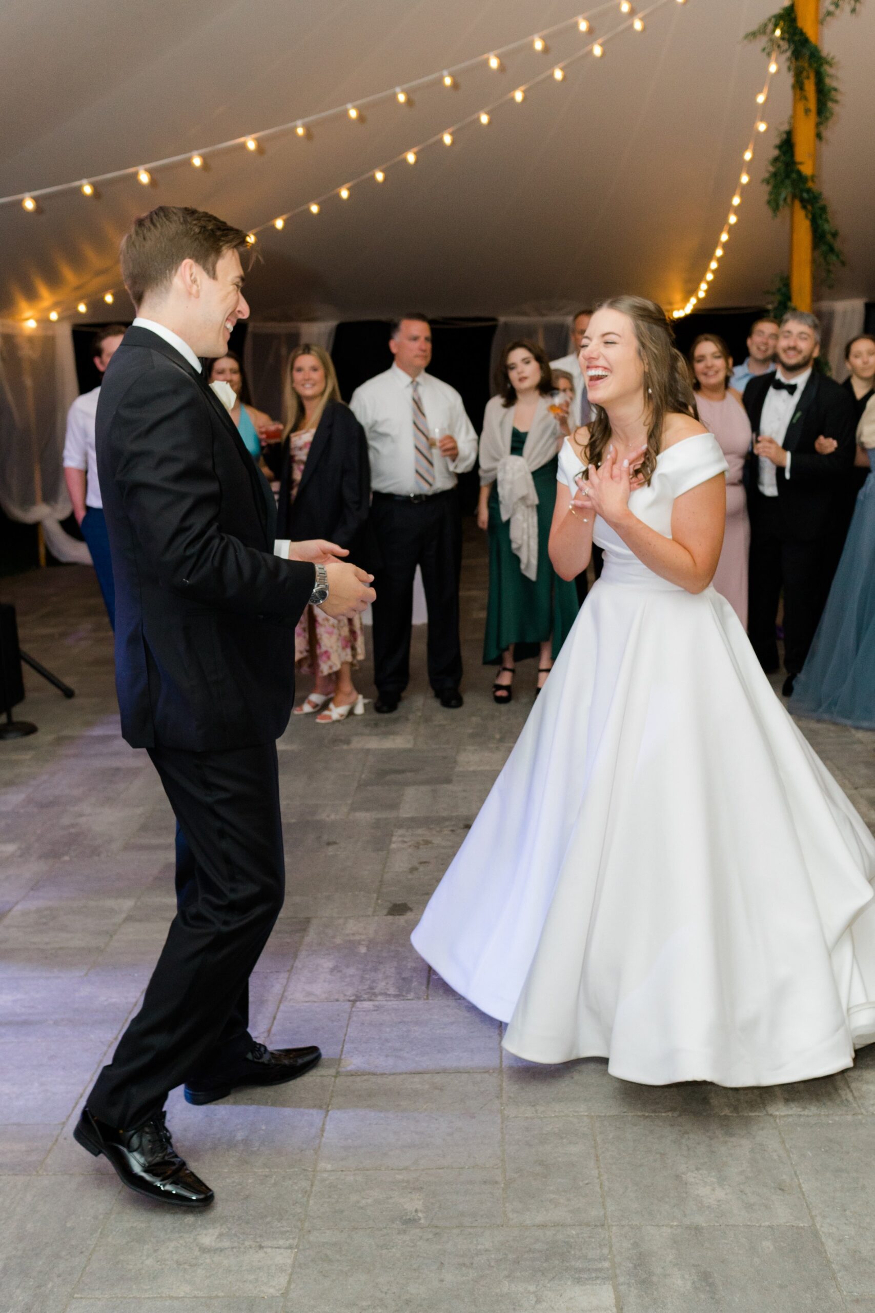 Elated bride has fun moment on the dance floor with her new husband. Boston wedding photographer.