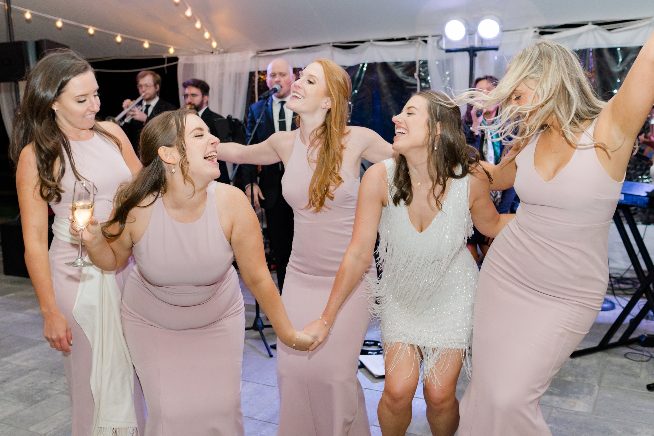 Bride and bridesmaids get down on the dance floor. Bride changes into fun second dress. Boston wedding photographer.