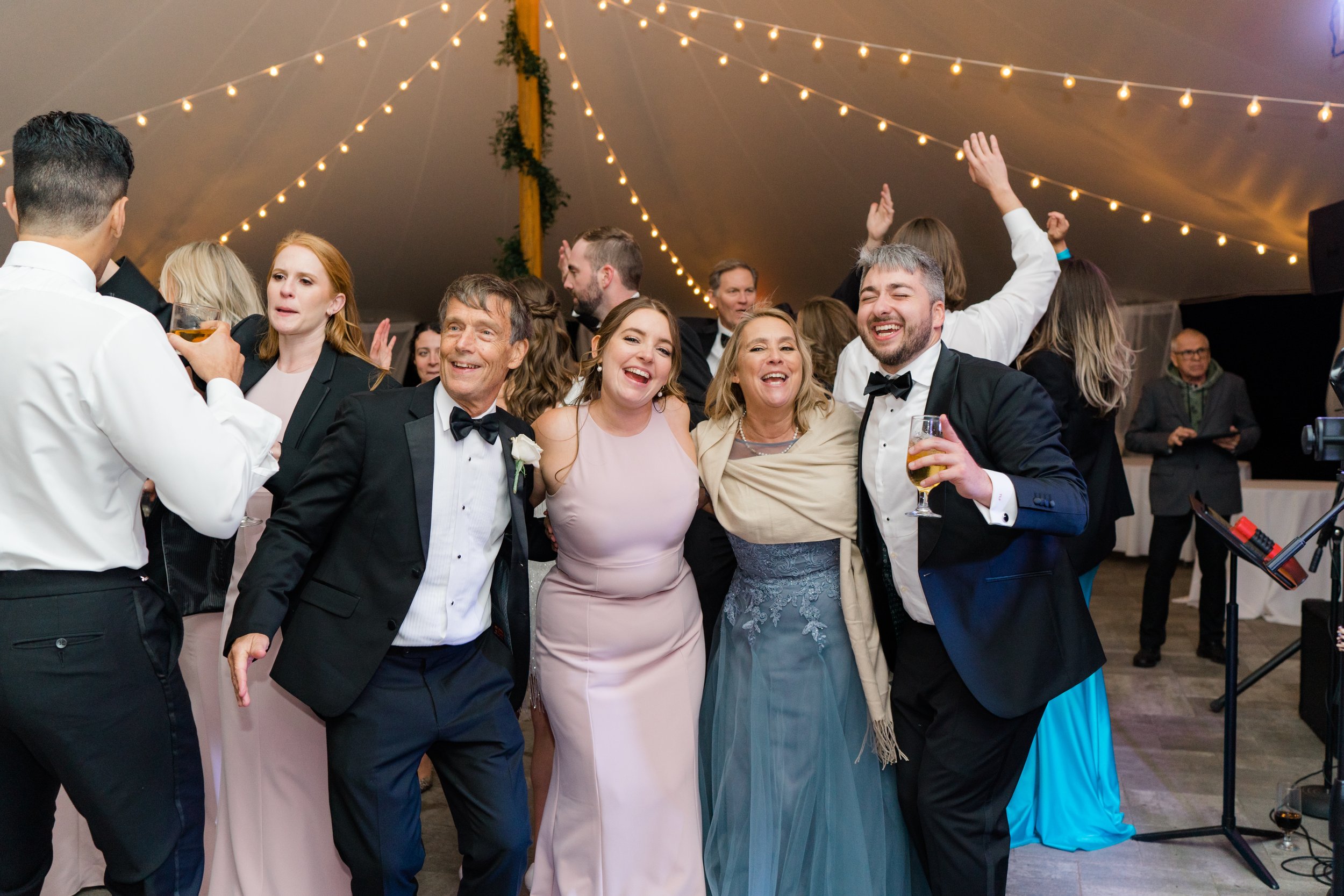 candid group photo on the dance floor during summer wedding.